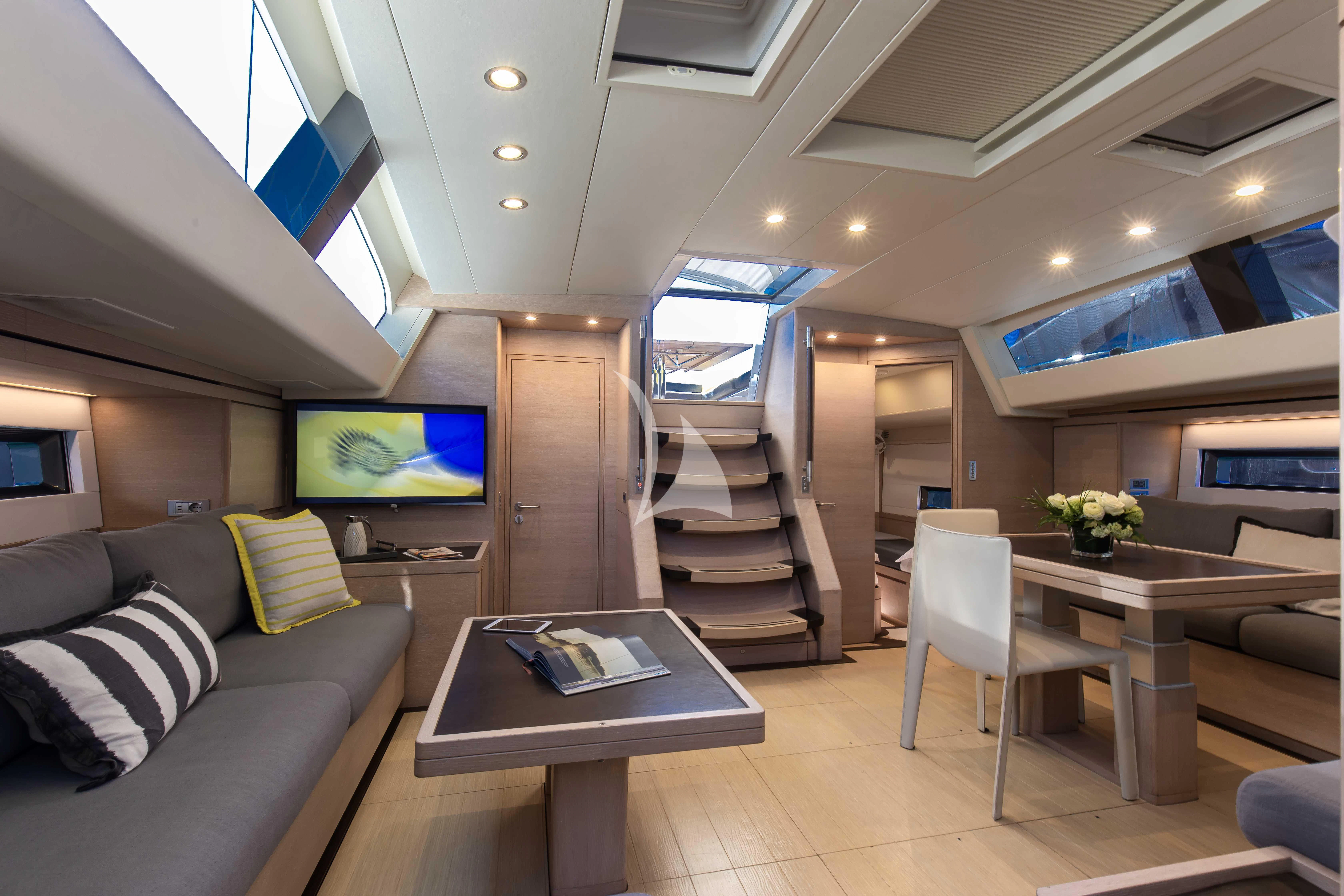a living room with a couch and a television aboard AMMONITE Yacht for Charter