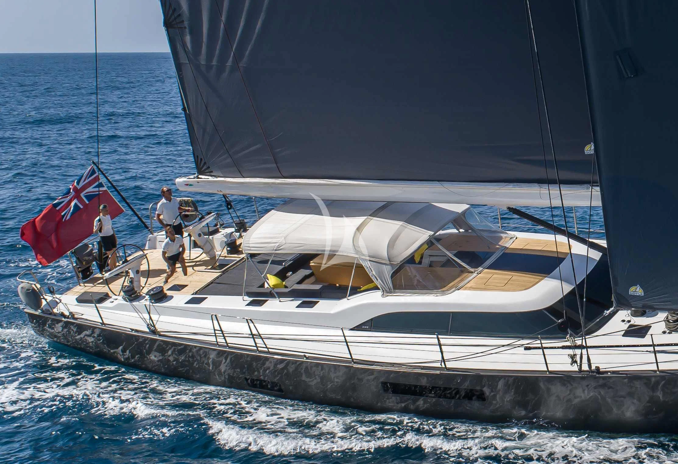 a boat with a sail on the water aboard AMMONITE Yacht for Charter