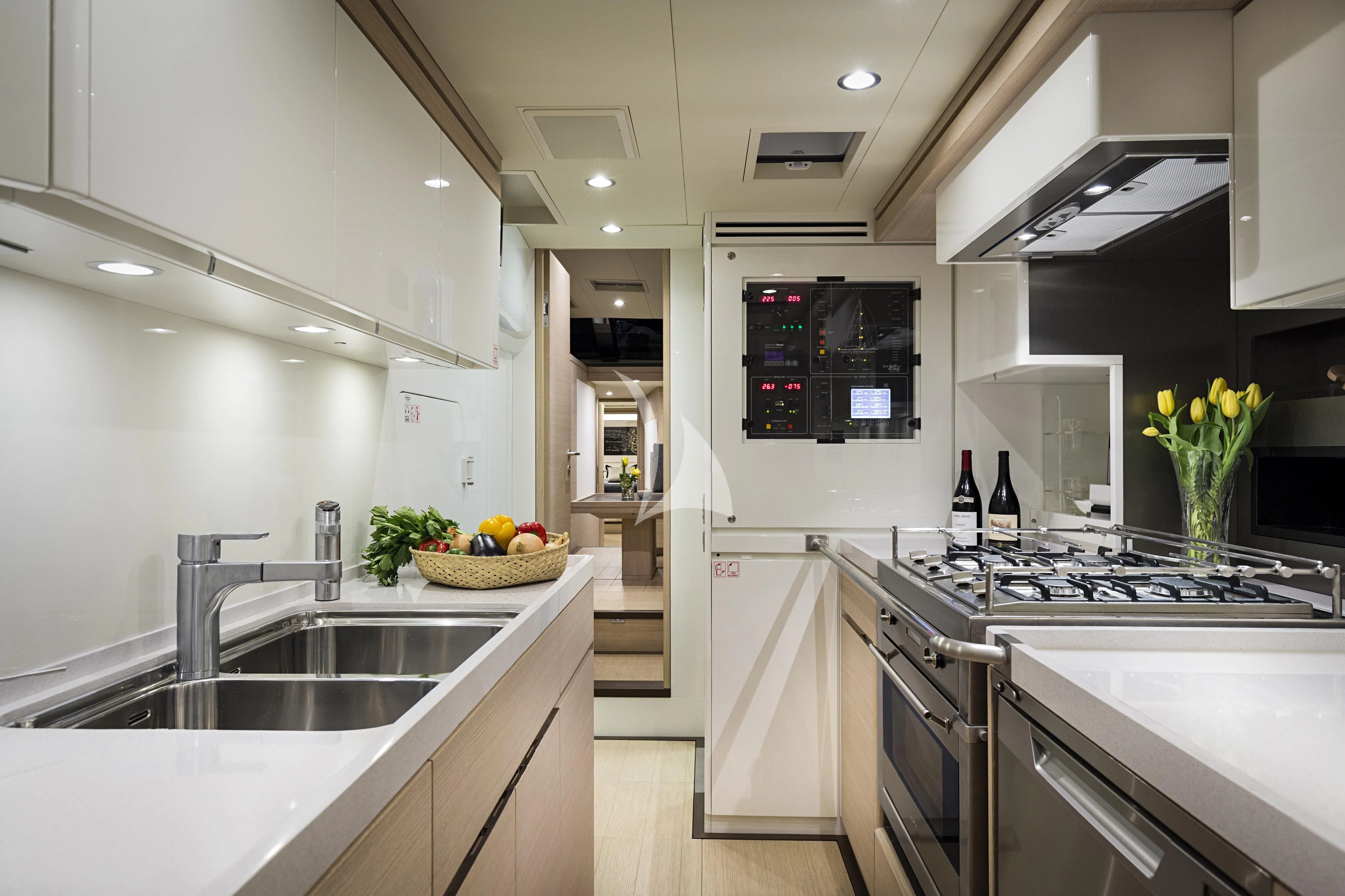 a kitchen with white cabinets aboard AMMONITE Yacht for Charter
