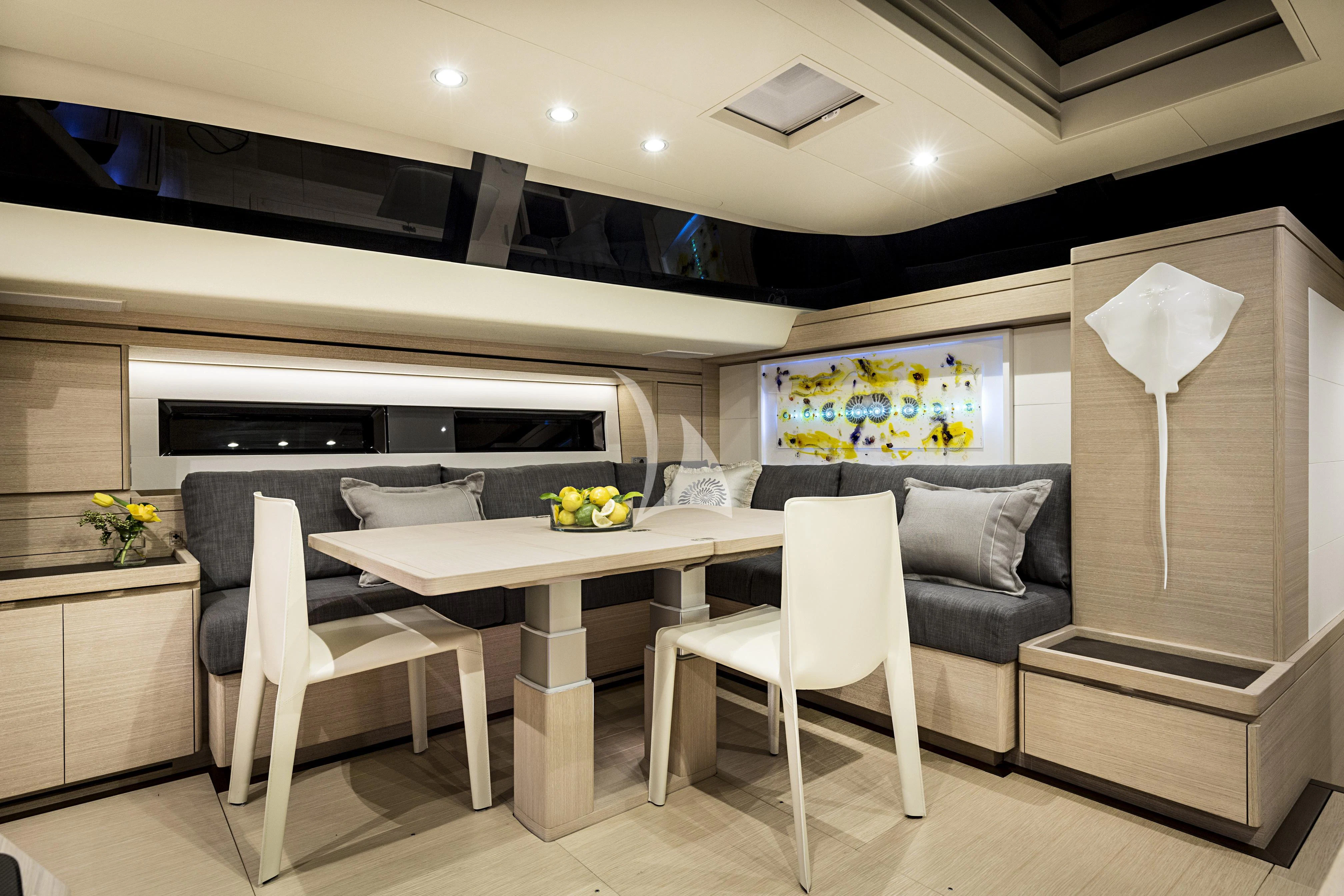 a kitchen with a table and chairs aboard AMMONITE Yacht for Charter