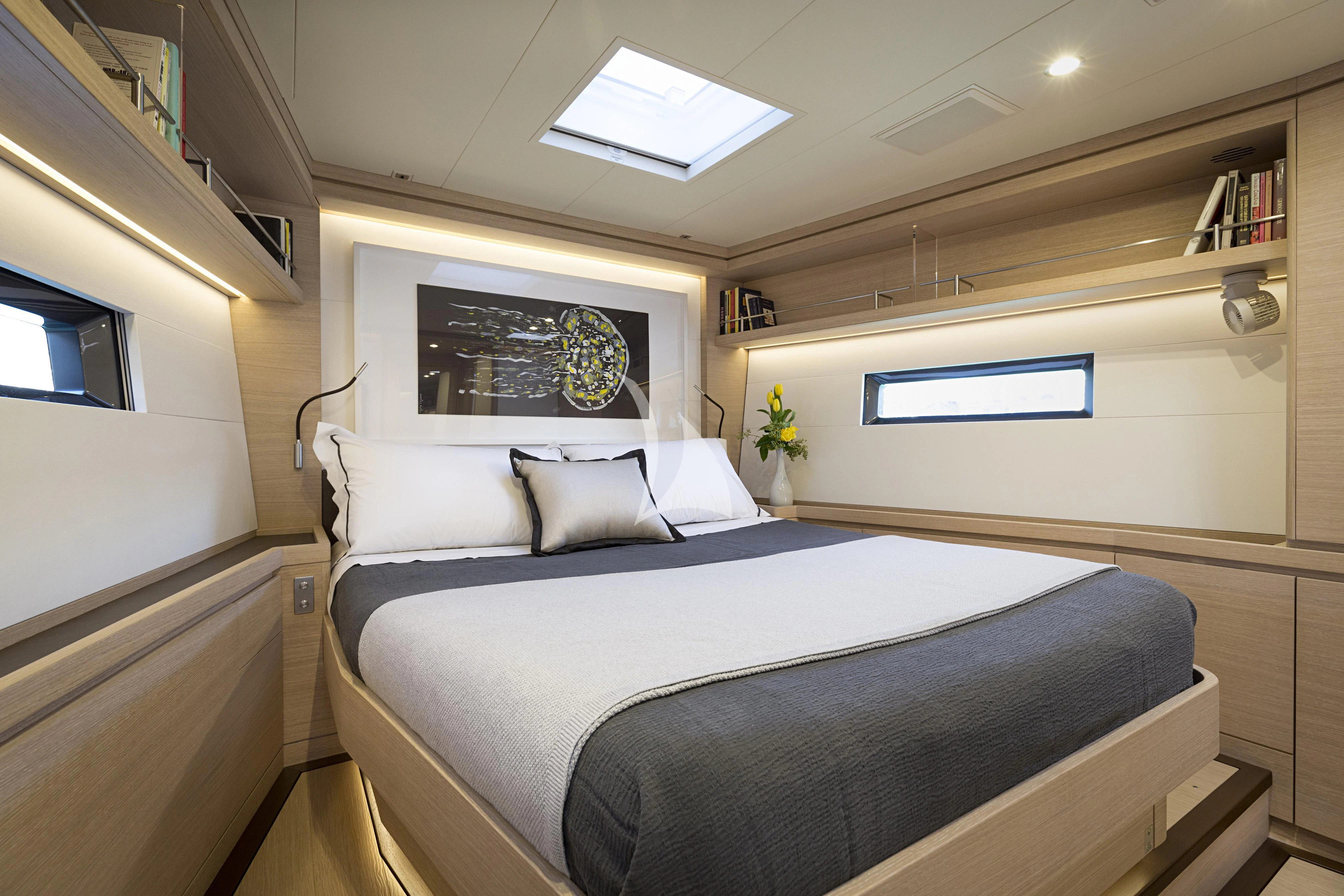 a room with a bed and a window aboard AMMONITE Yacht for Charter