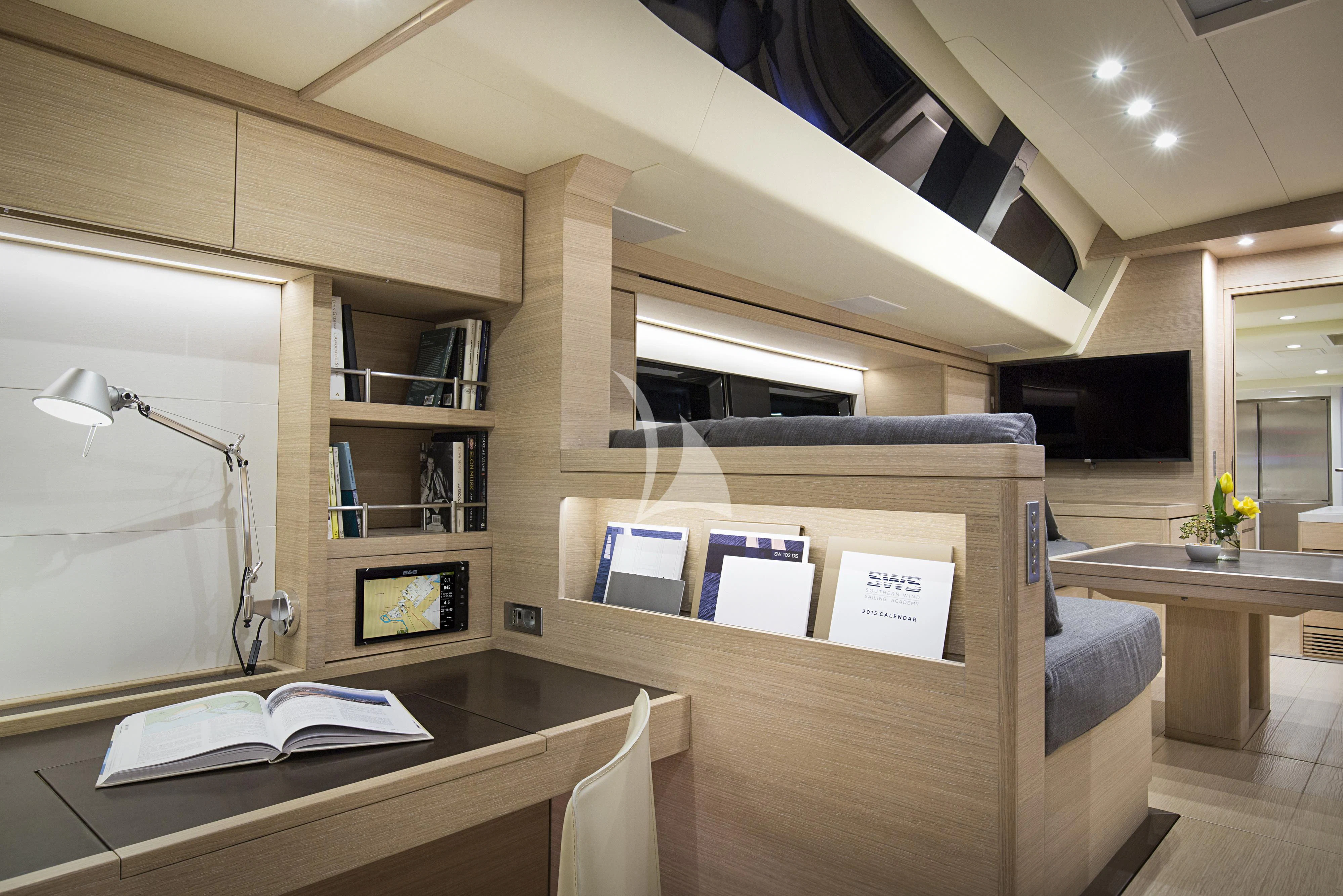 a room with a desk and a computer aboard AMMONITE Yacht for Charter