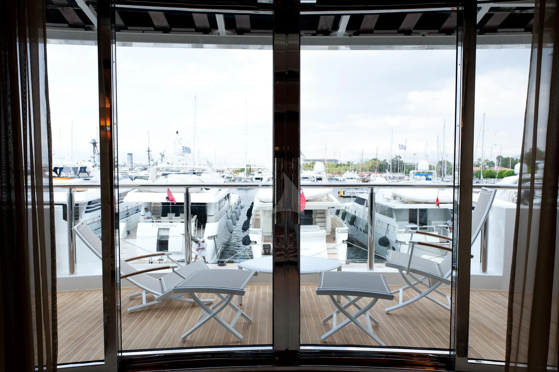 a room with a view of the city and a large window aboard I SEA Yacht for Charter