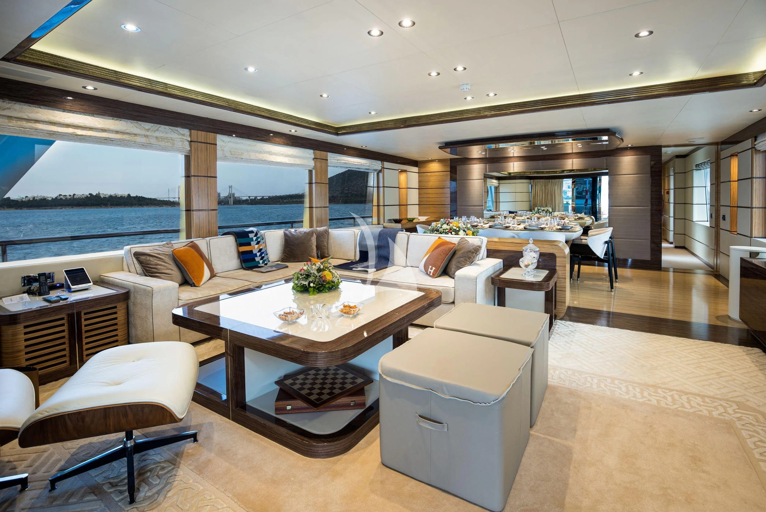 a large living room with a large table and chairs aboard I SEA Yacht for Charter