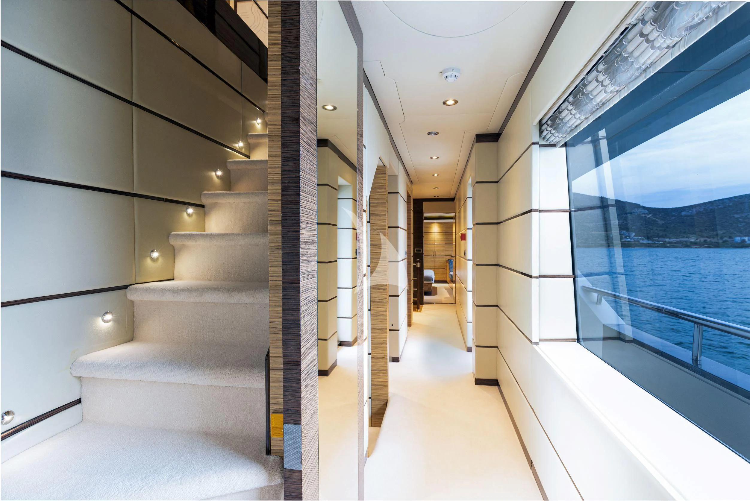 a hallway with glass walls aboard I SEA Yacht for Charter