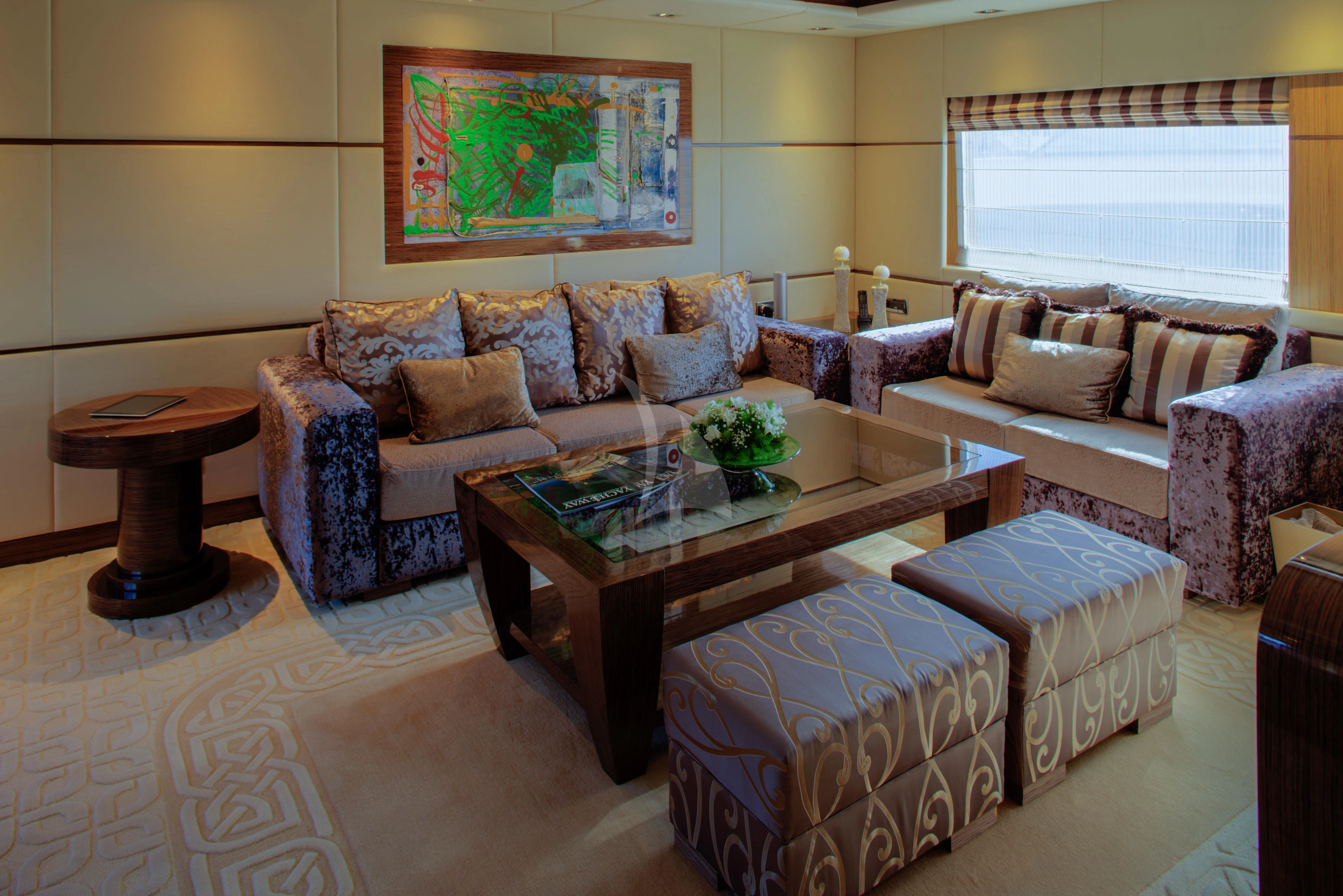 a living room with a table and couches aboard I SEA Yacht for Charter
