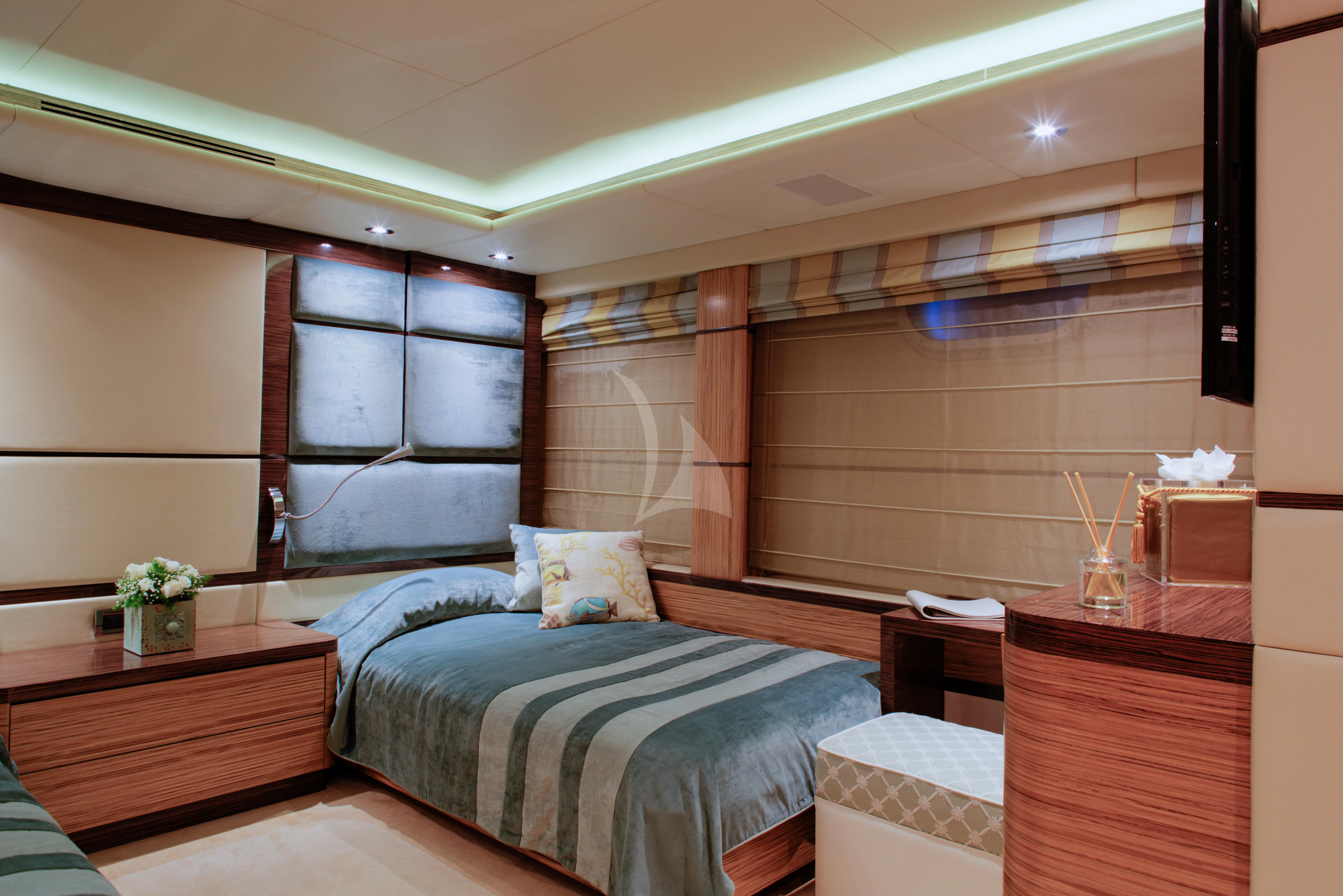 a bedroom with a bed and a desk aboard I SEA Yacht for Charter