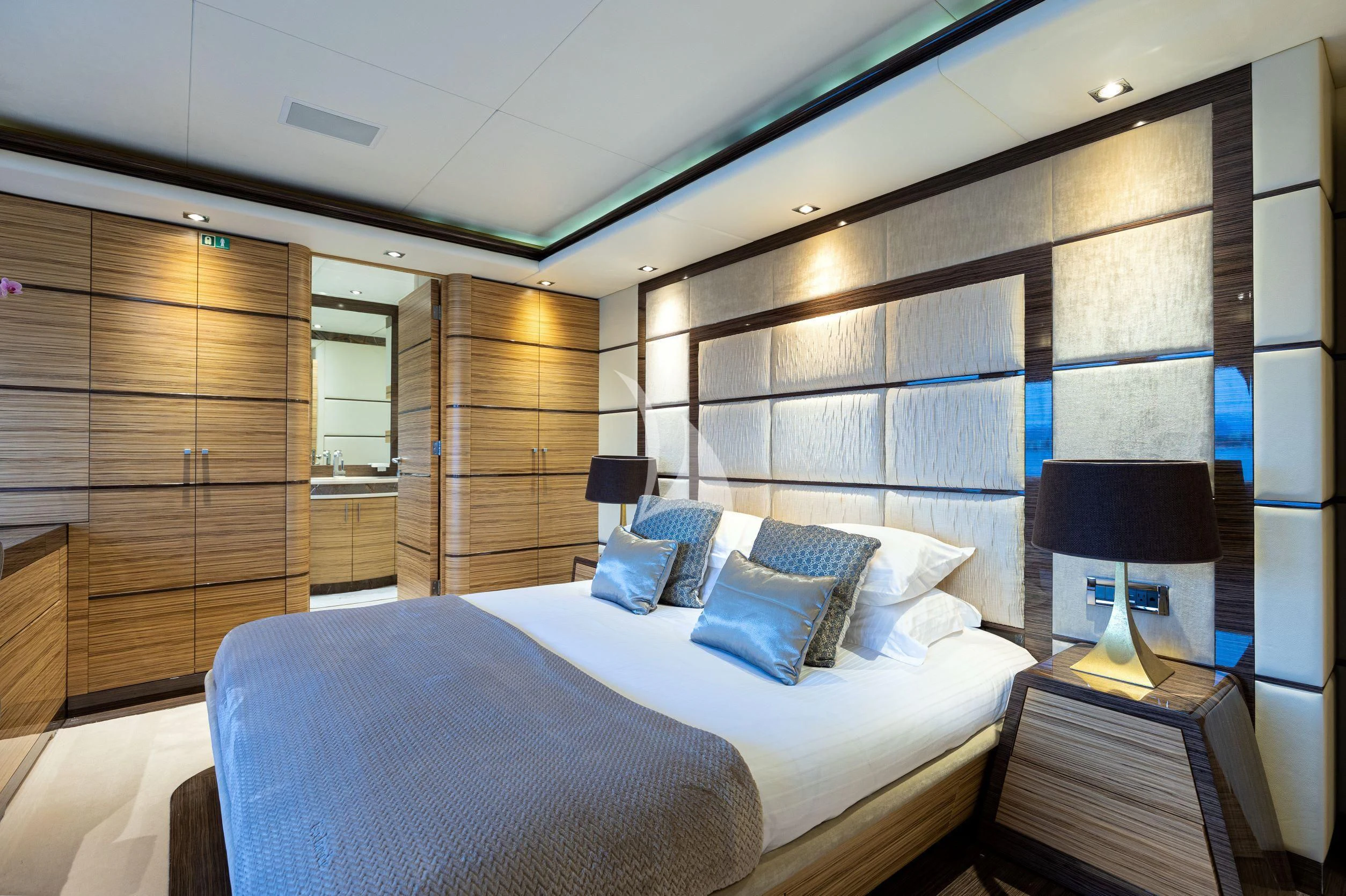 a room with a bed and a lamp aboard I SEA Yacht for Charter