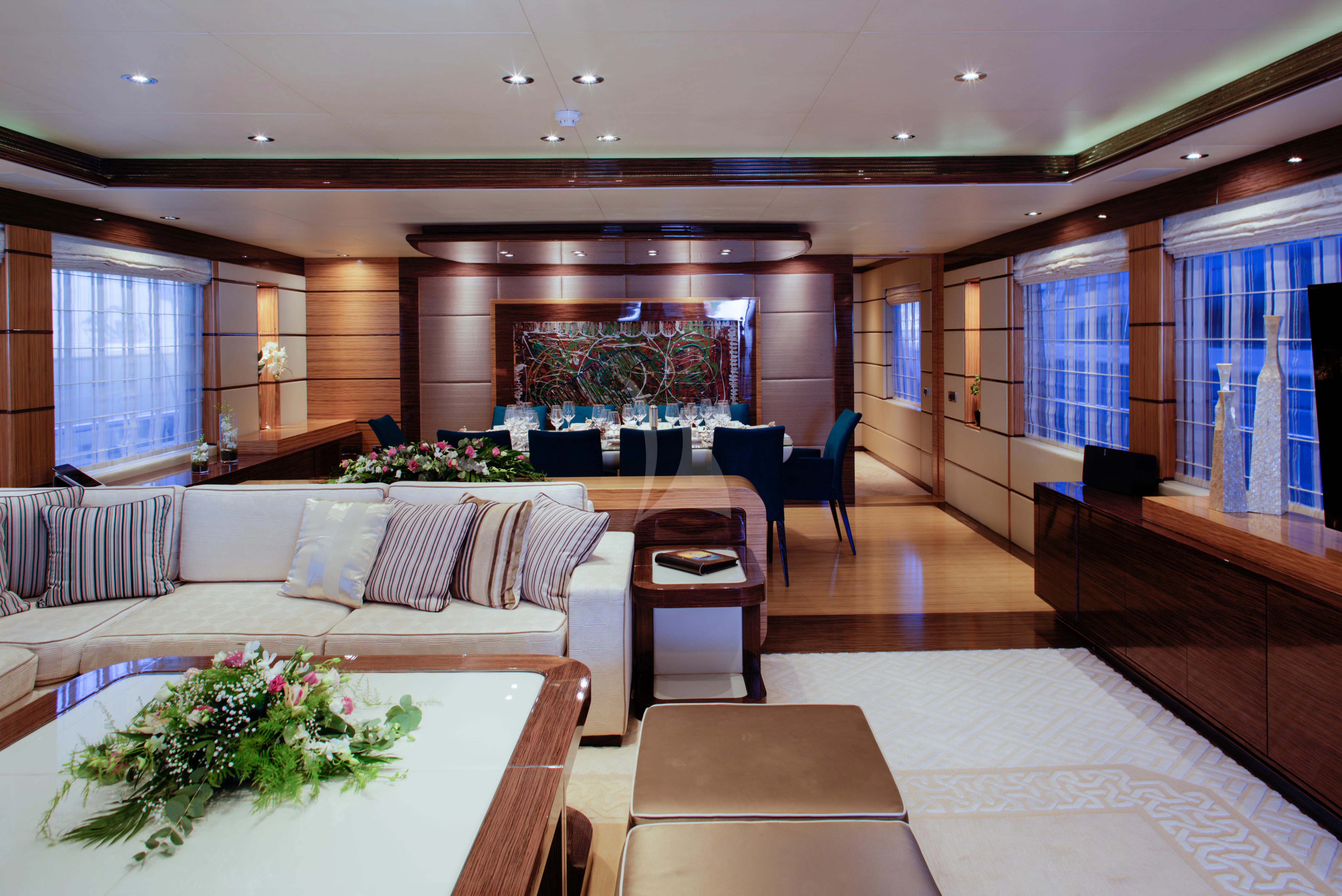 a large living room with a large table and chairs aboard I SEA Yacht for Charter