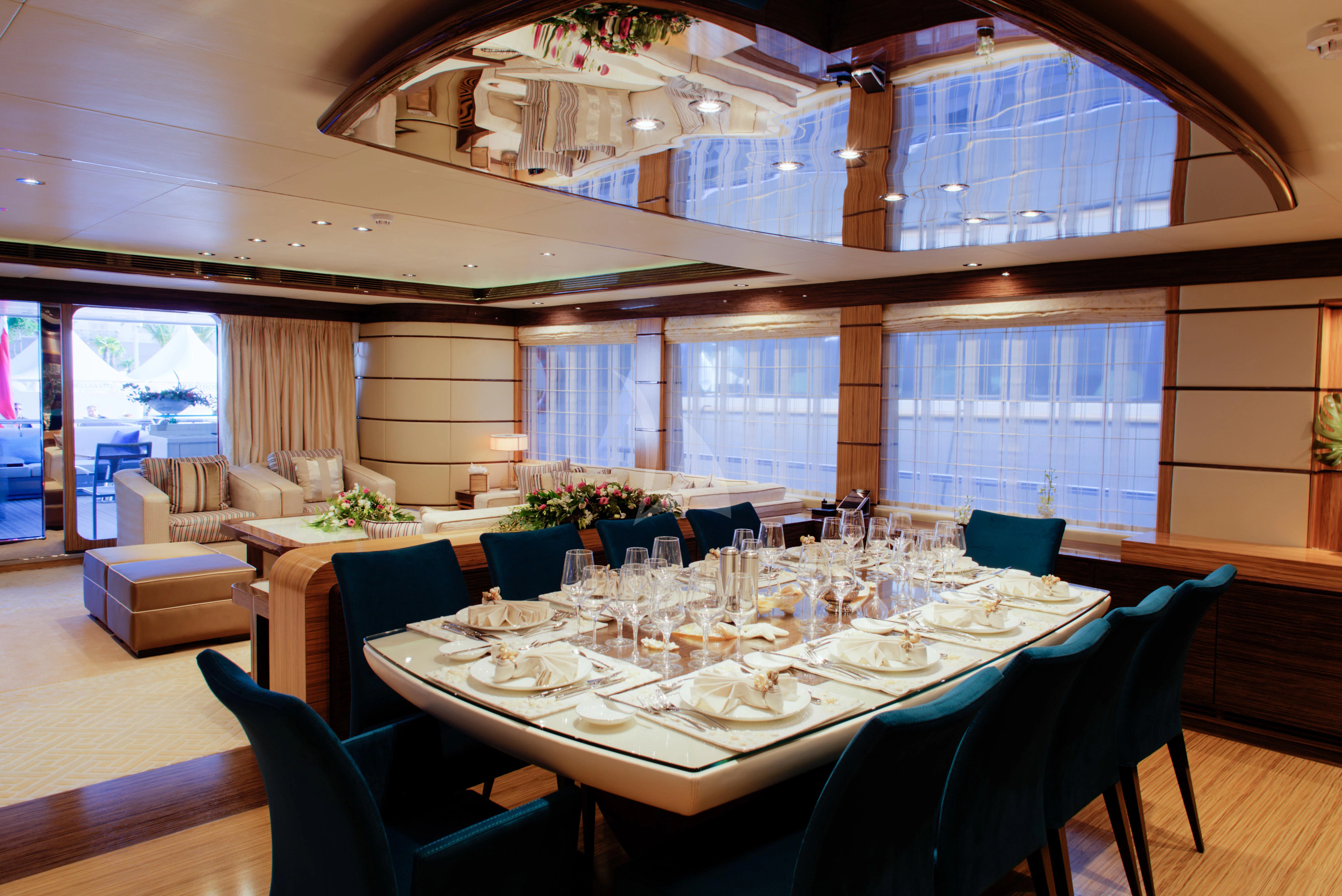 a large room with a table and chairs aboard I SEA Yacht for Charter