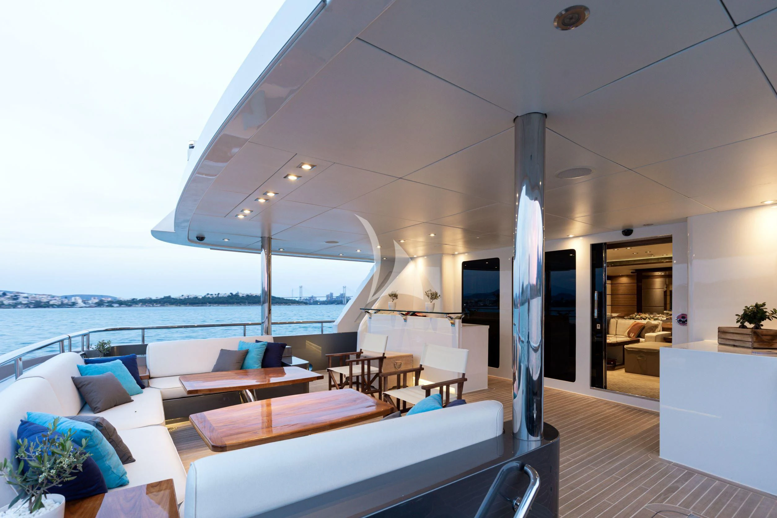 a room with a couch and a table and a large window aboard I SEA Yacht for Charter