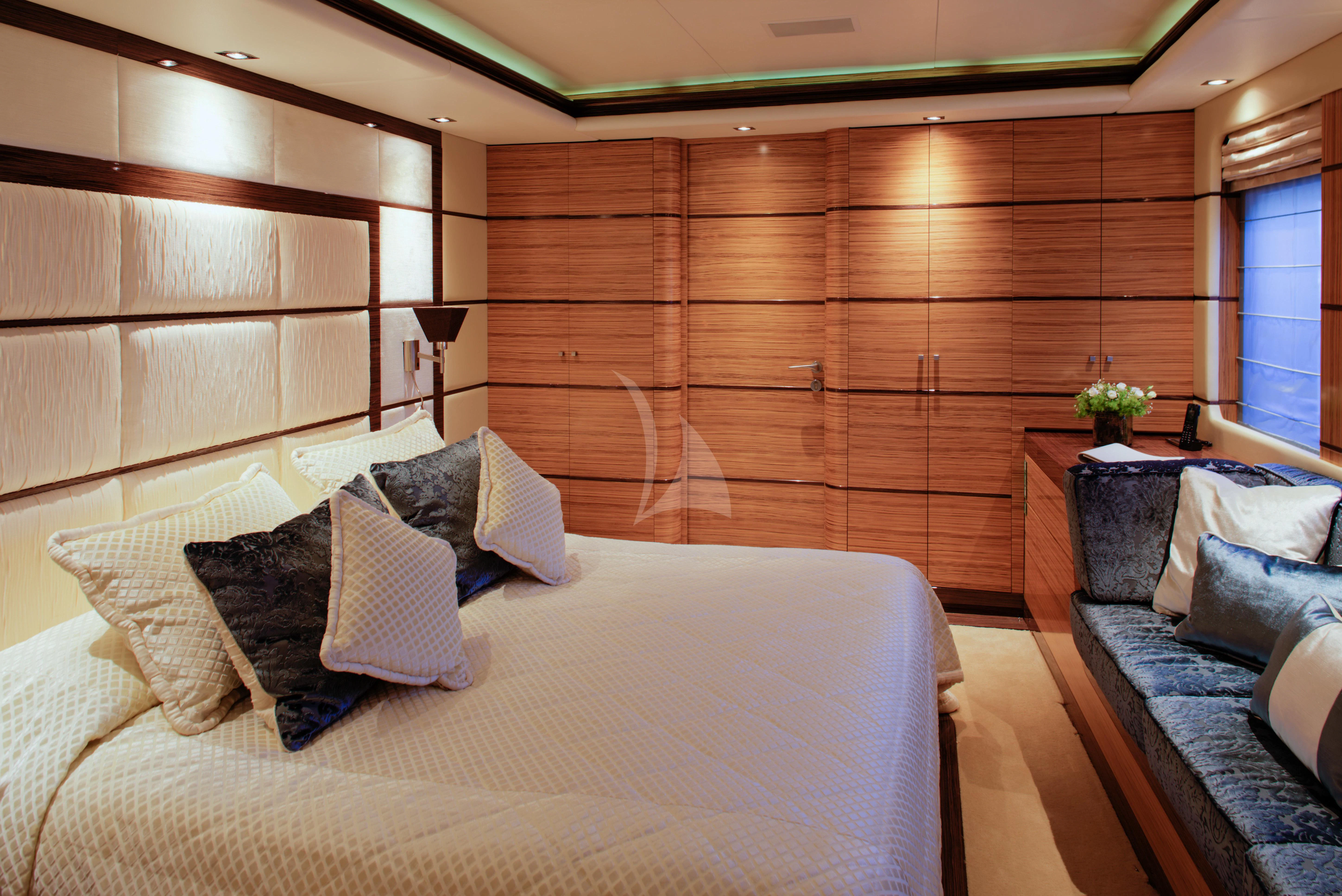 a room with a bed and a couch aboard I SEA Yacht for Charter