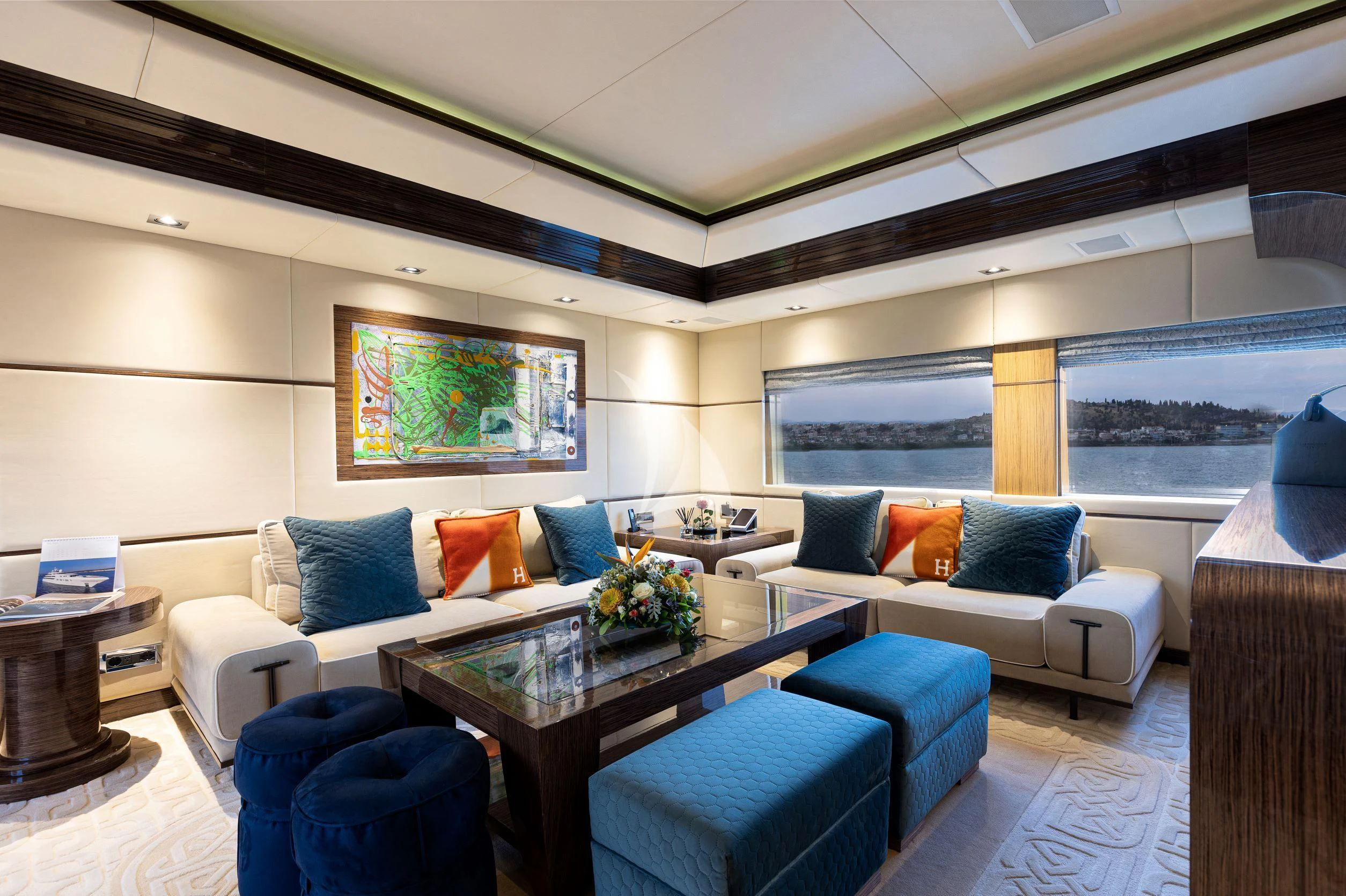a living room with a blue couch and a table aboard I SEA Yacht for Charter
