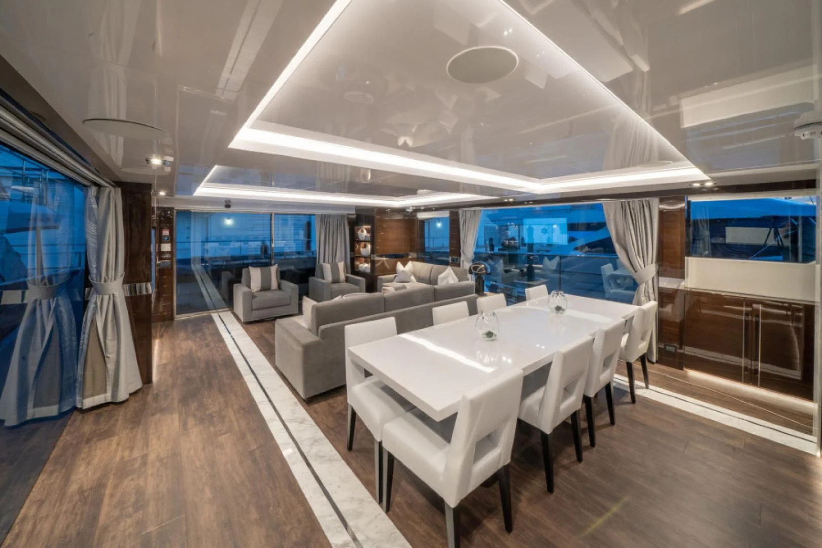 a large room with a long table and chairs aboard PEARL Yacht for Sale
