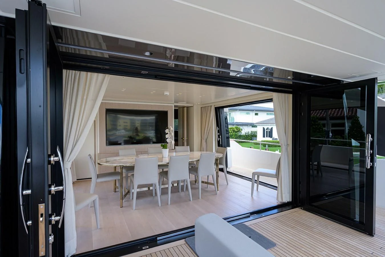 a room with a table and chairs aboard PEARL Yacht for Sale