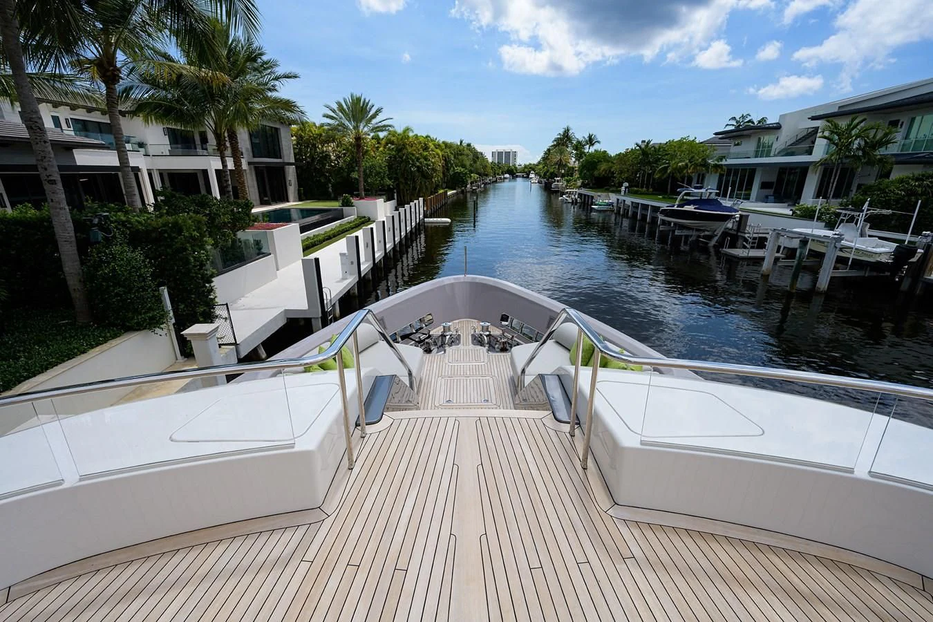 a deck with a pool and a deck with chairs and trees aboard PEARL Yacht for Sale