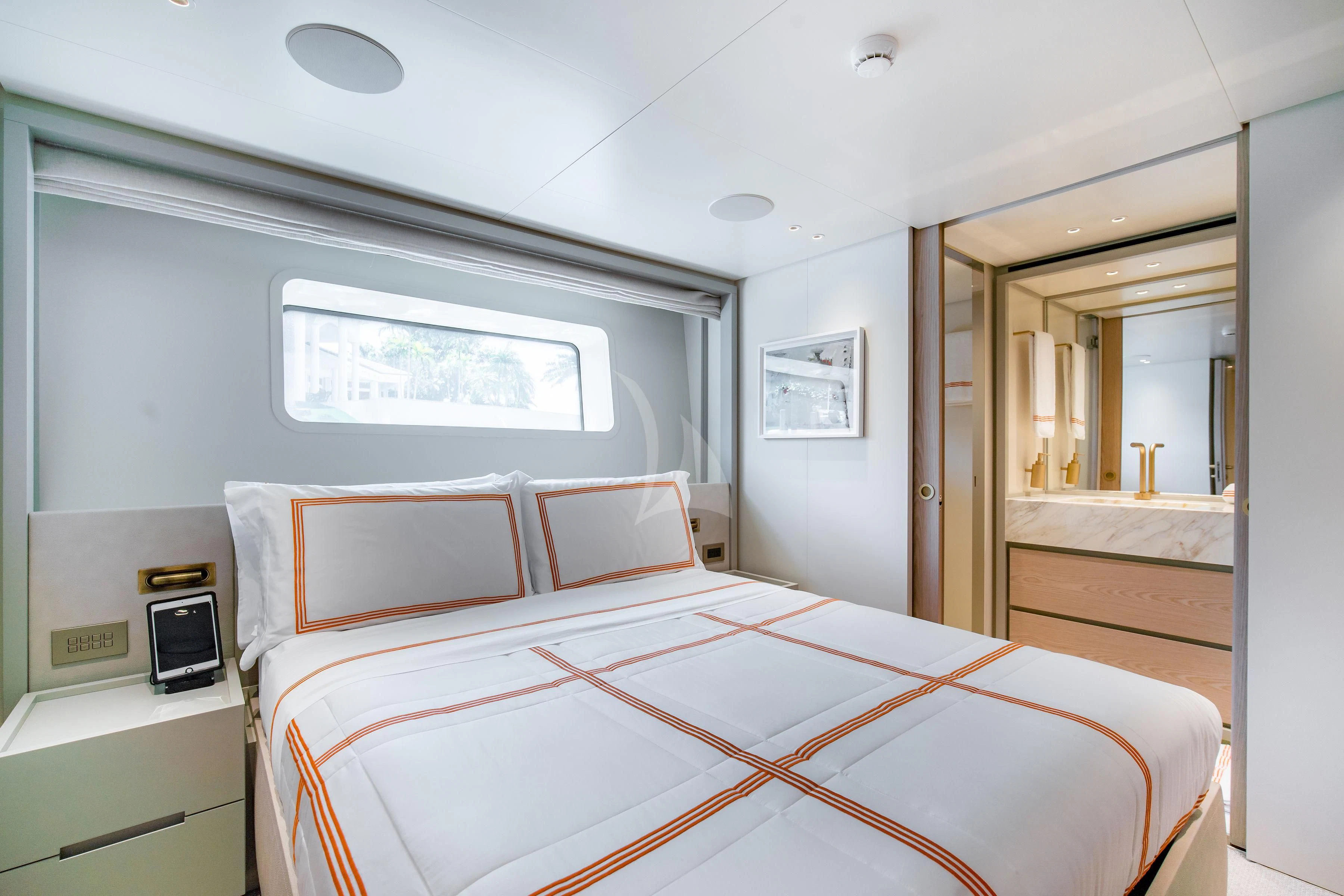 a room with a bed and a mirror aboard PEARL Yacht for Sale