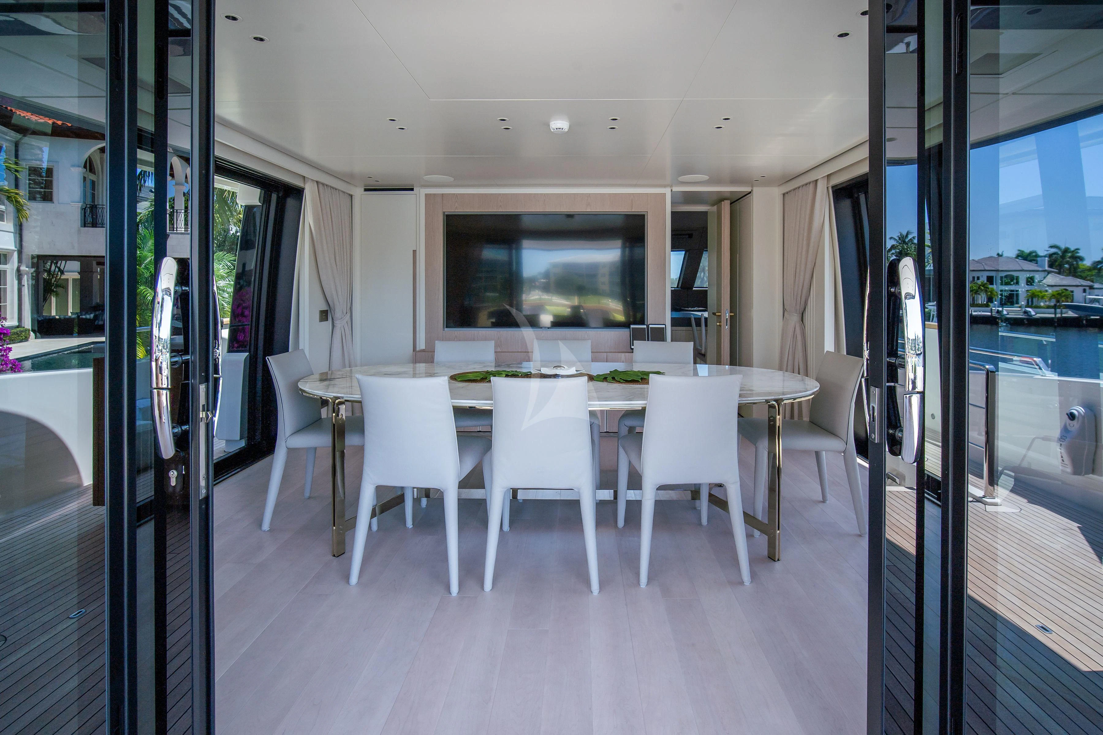a room with a table and chairs aboard PEARL Yacht for Sale