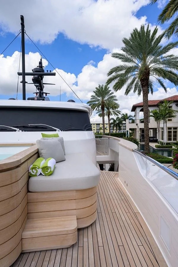 a deck with a wood railing and a white boat on it aboard PEARL Yacht for Sale