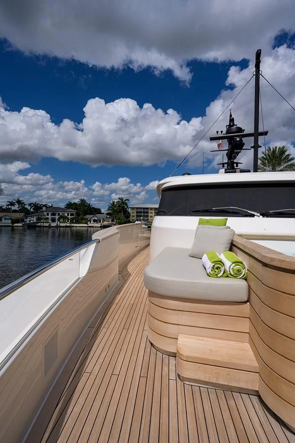 a deck with a boat and a chair on it aboard PEARL Yacht for Sale