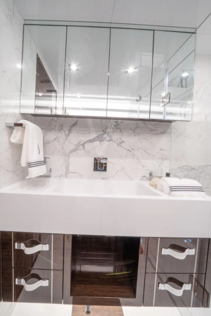 a bathroom with a sink and mirror aboard PEARL Yacht for Sale