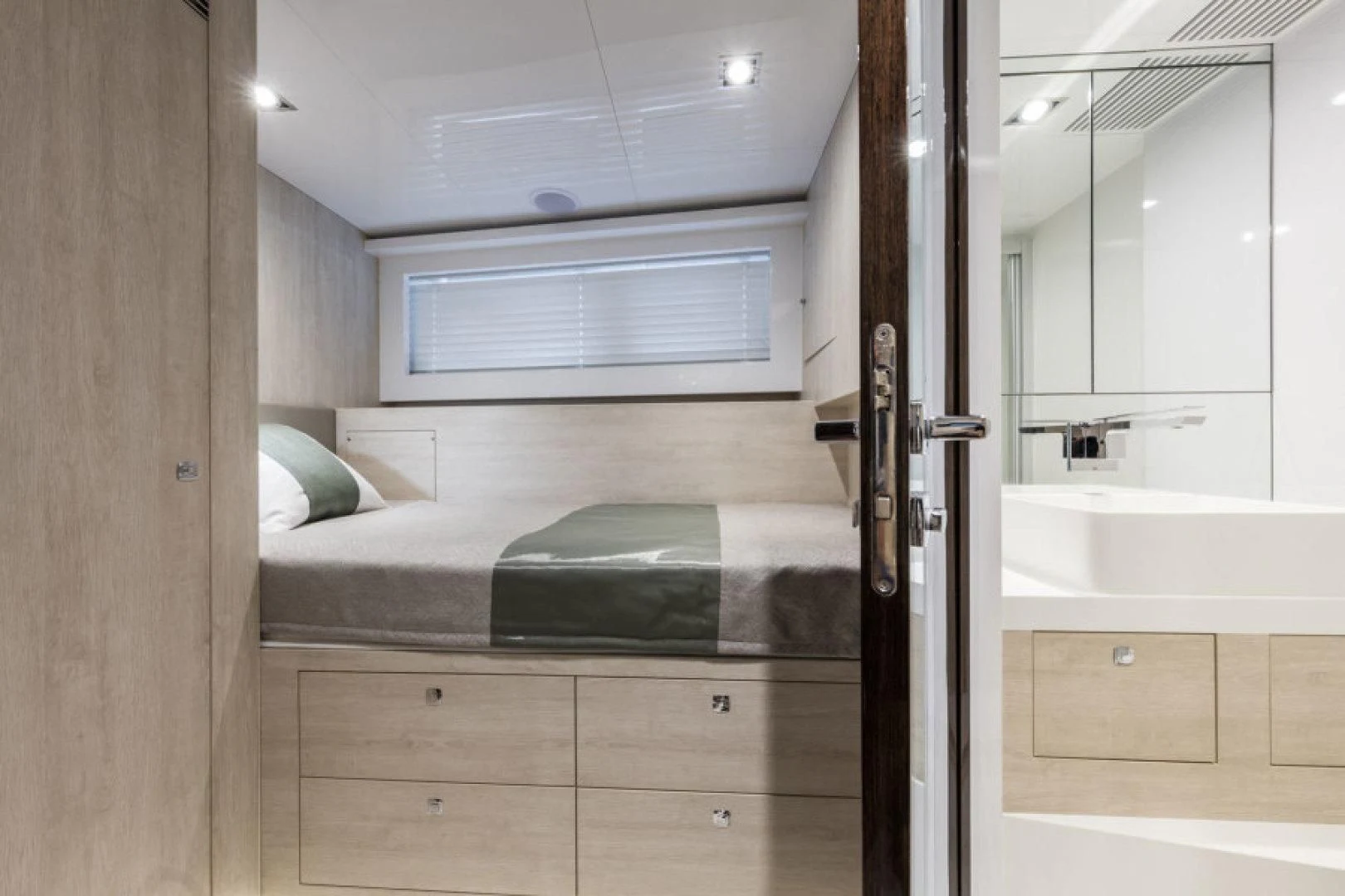 a bedroom with a bed and a sink aboard PEARL Yacht for Sale