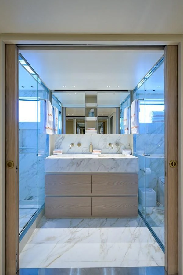 a room with a bed and a mirror aboard PEARL Yacht for Sale