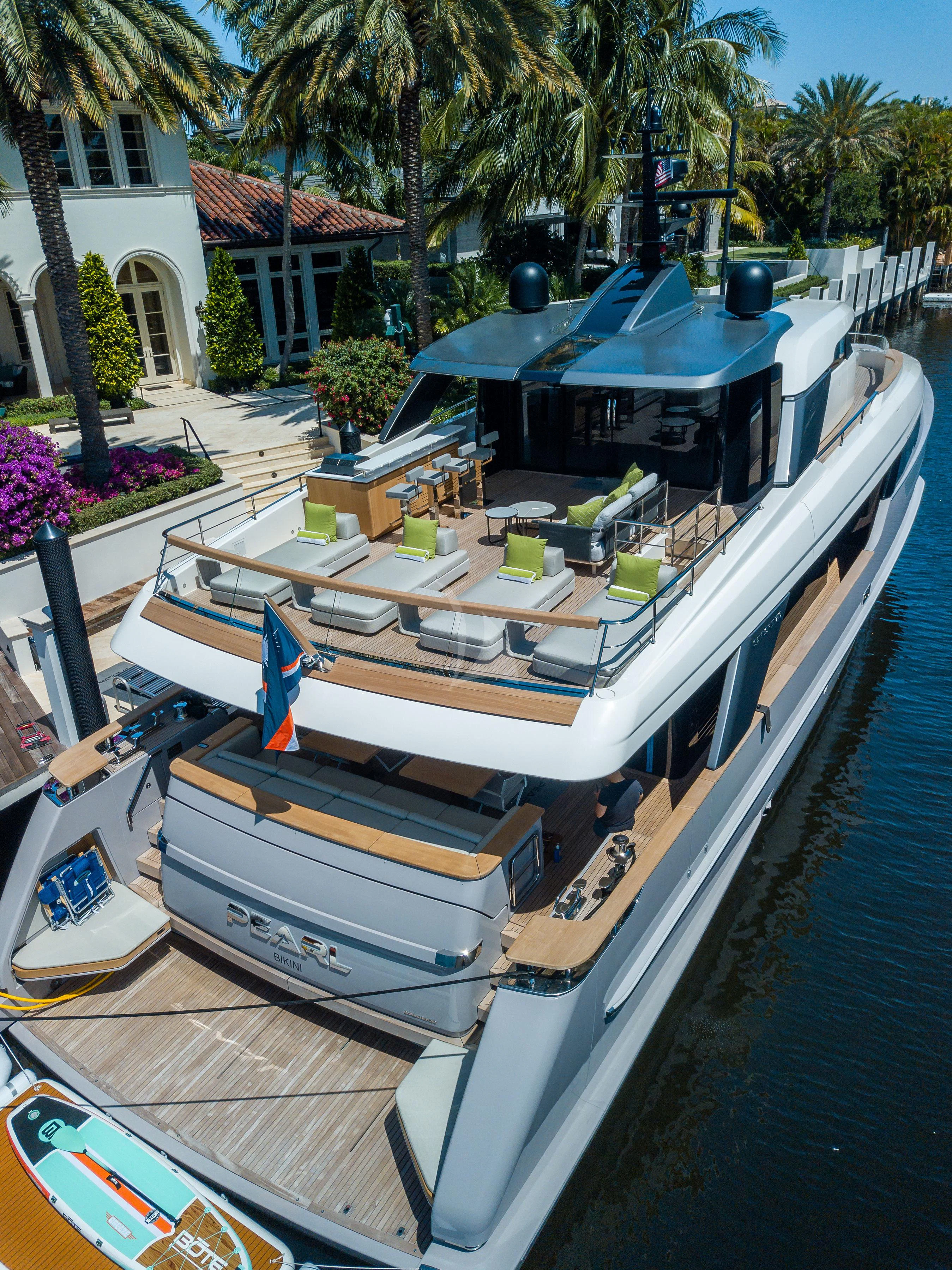 a boat with a deck and a deck with many chairs and tables aboard PEARL Yacht for Sale