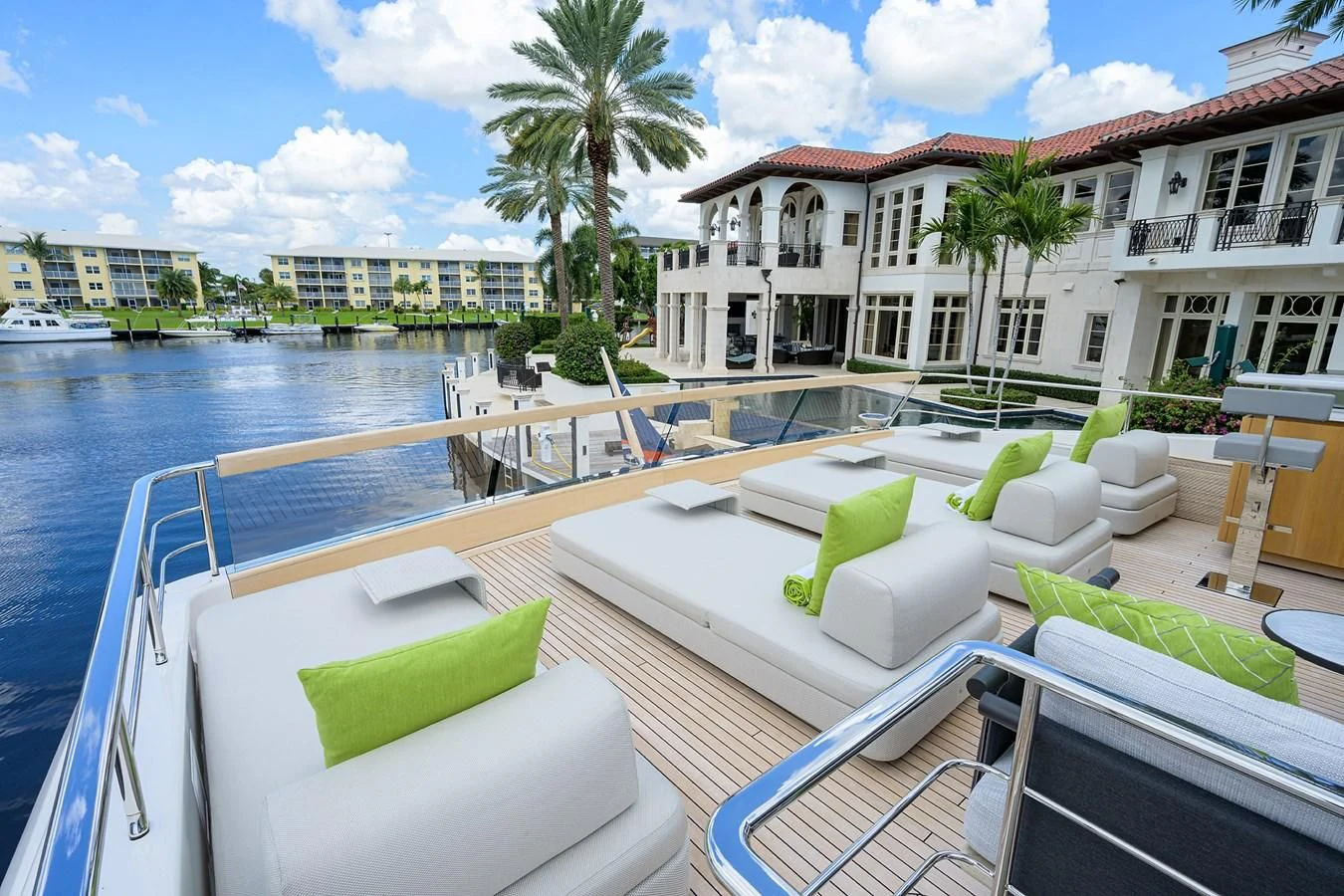a pool with lounge chairs and a building in the background aboard PEARL Yacht for Sale