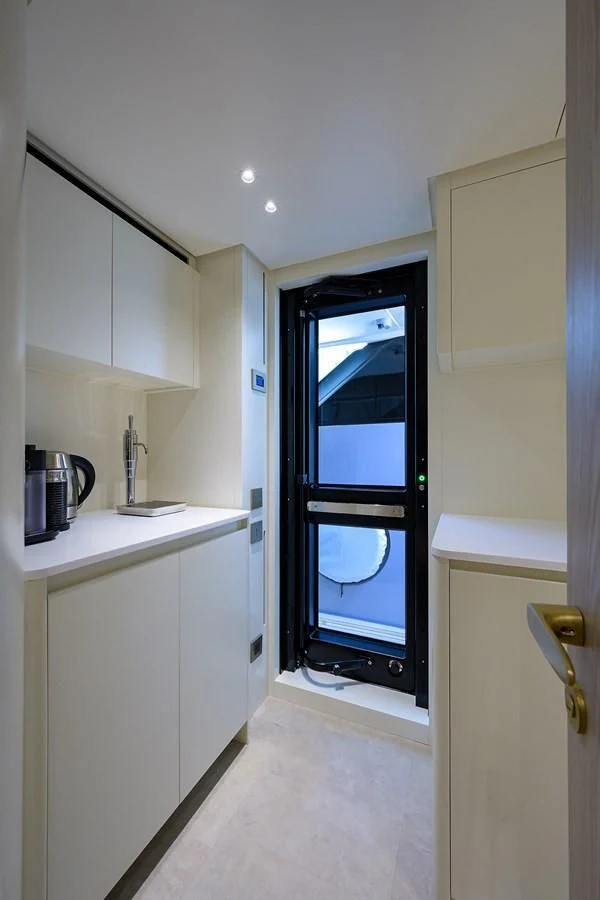 a kitchen with a large window aboard PEARL Yacht for Sale