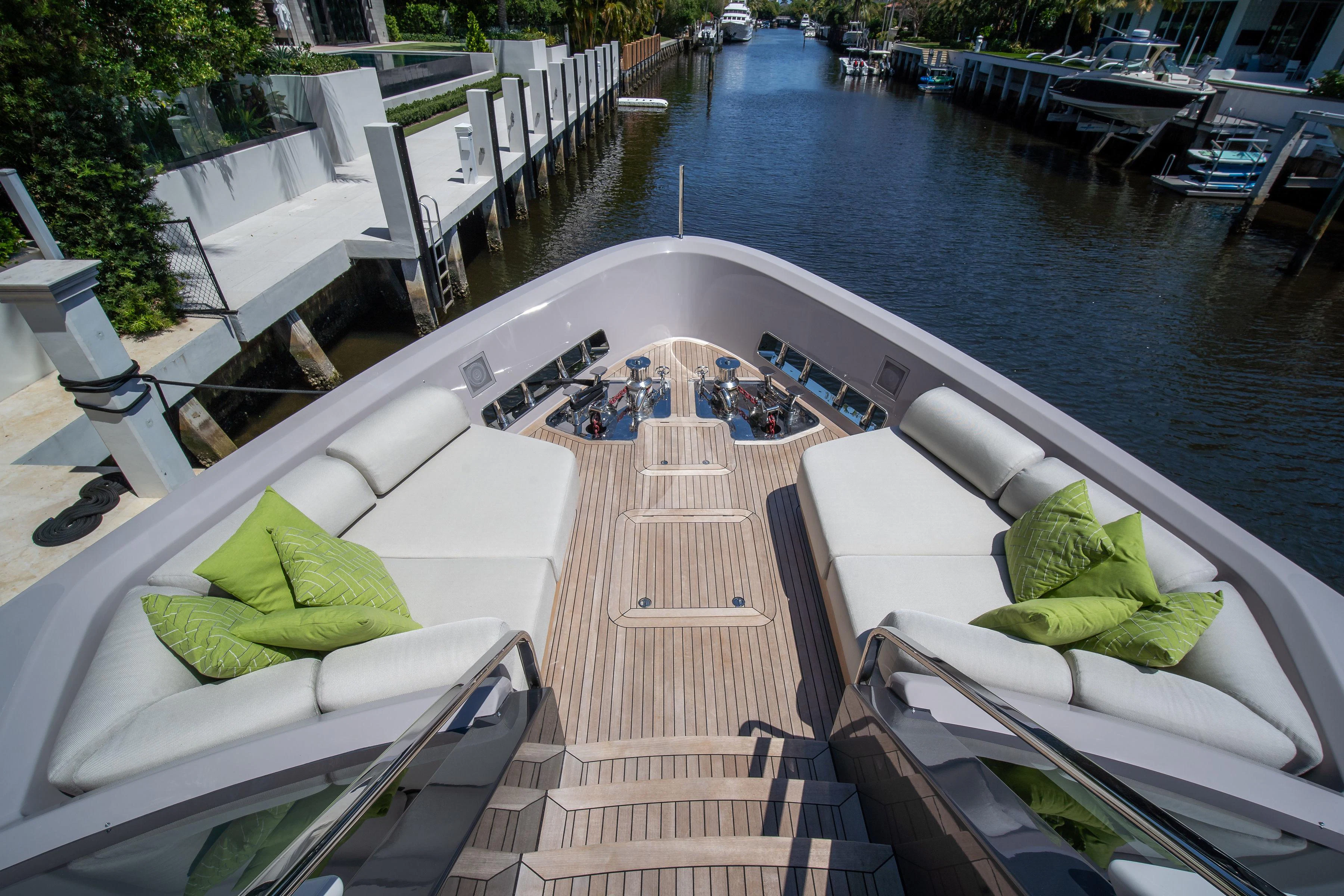 a deck with a pool and lounge chairs on it aboard PEARL Yacht for Sale