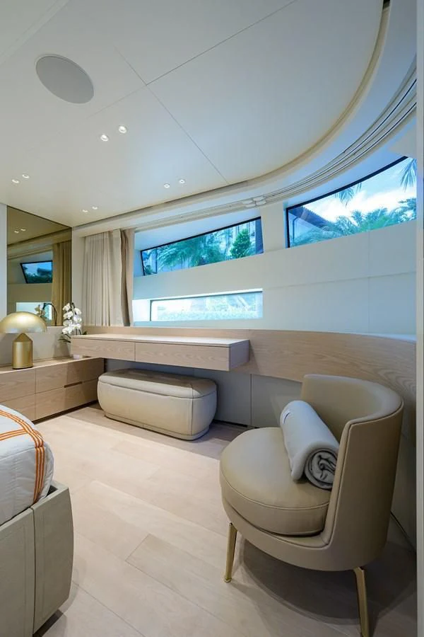 a room with a white chair and a large window aboard PEARL Yacht for Sale