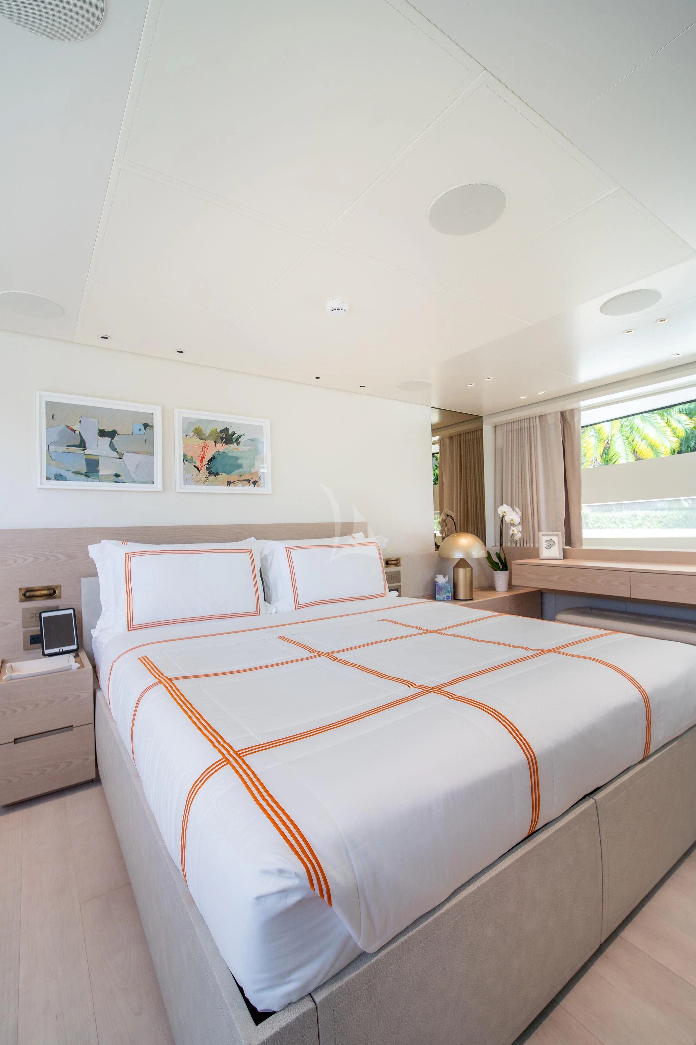 a bedroom with a bed and a window aboard PEARL Yacht for Sale