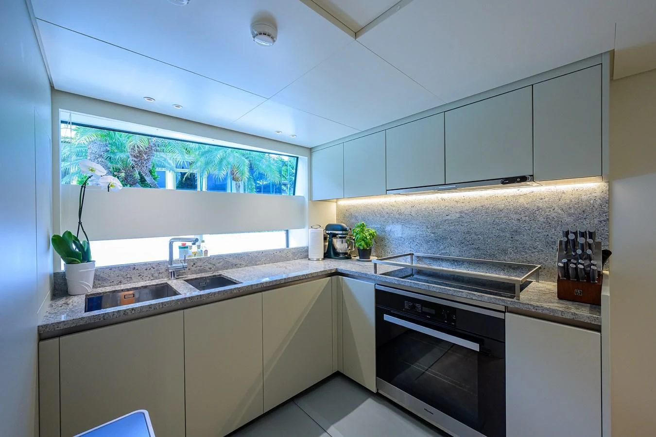 a kitchen with a window aboard PEARL Yacht for Sale