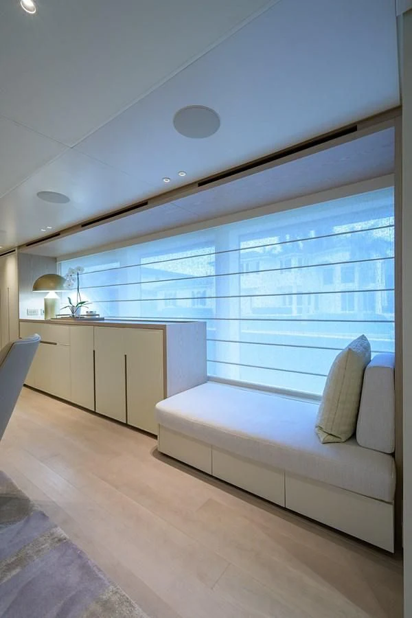 a room with a couch and a window aboard PEARL Yacht for Sale