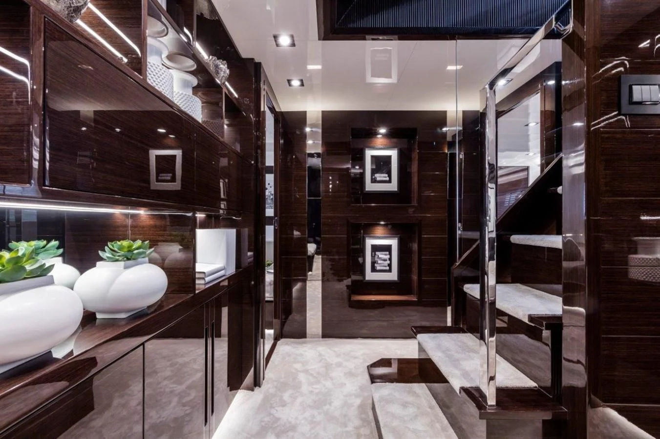 a room with a staircase and a large mirror aboard PEARL Yacht for Sale