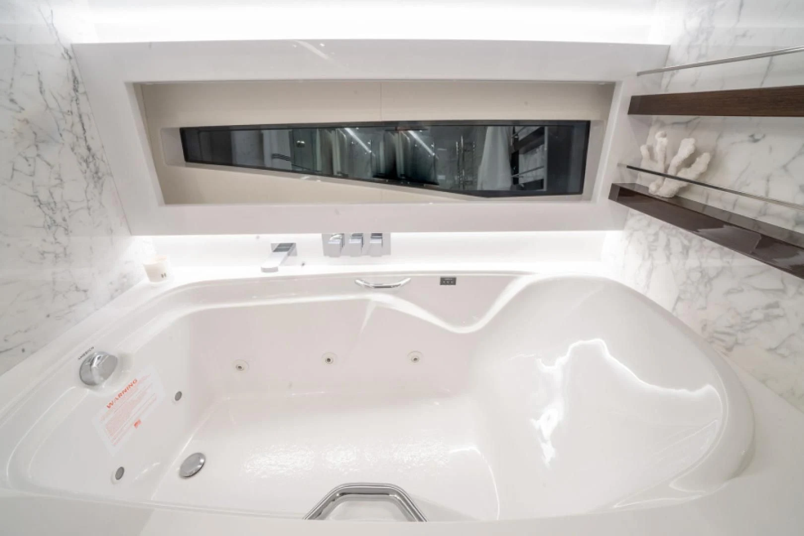 a bathtub with a bottle of wine aboard PEARL Yacht for Sale