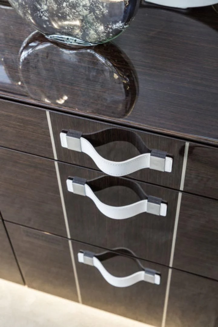 a silver and black metal box with a silver lid and a silver metal lid on a wooden surface aboard PEARL Yacht for Sale