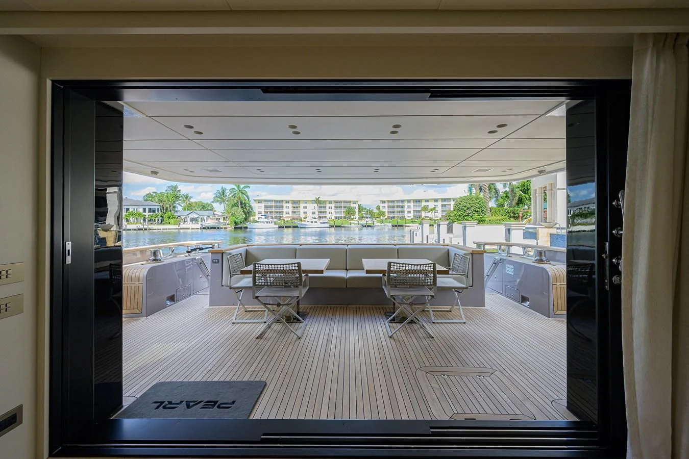 a room with tables and chairs aboard PEARL Yacht for Sale