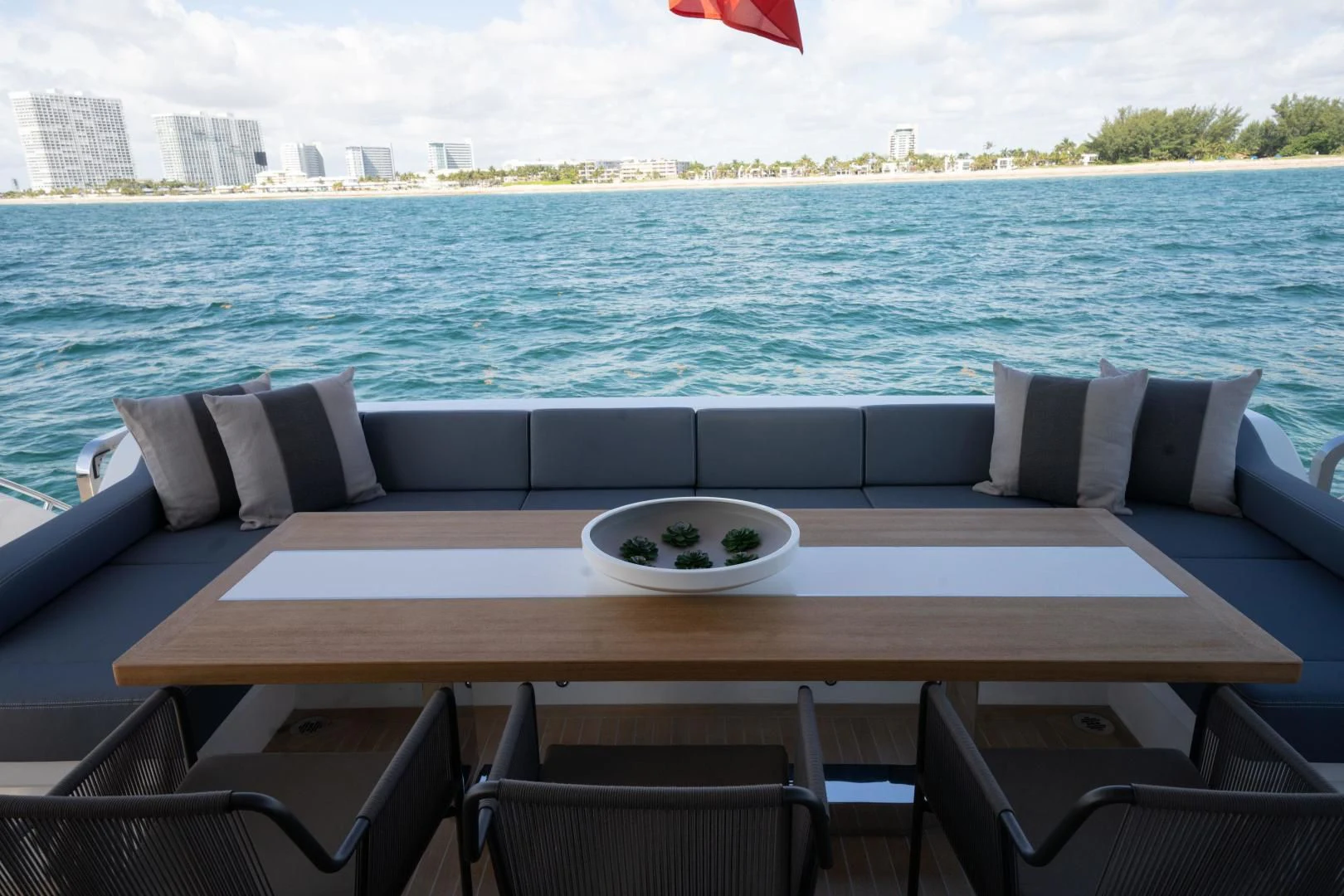 a table with chairs on it by the water aboard PEARL Yacht for Sale
