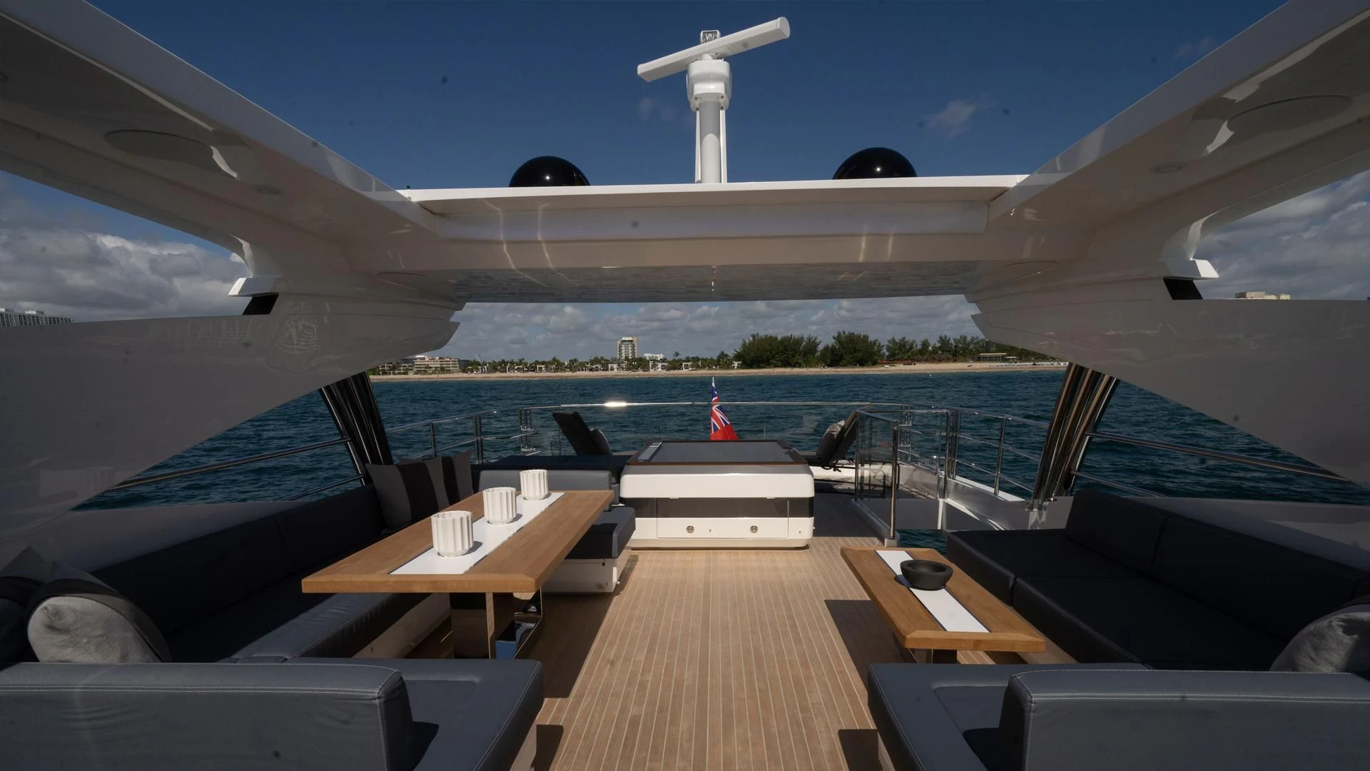 a deck with a large white building and a white windmill on the horizon aboard PEARL Yacht for Sale
