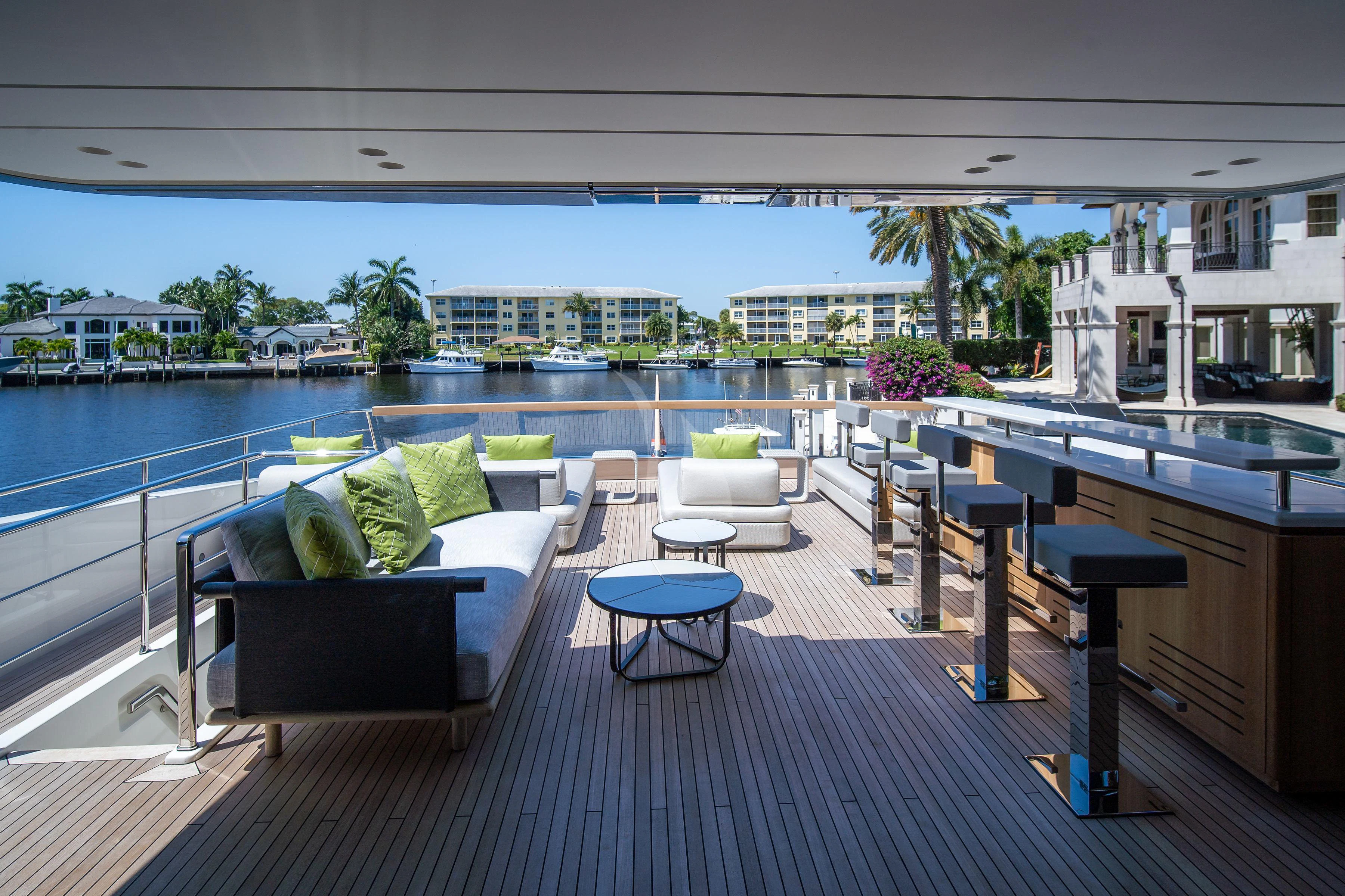 a room with a pool and a deck with a view of the city aboard PEARL Yacht for Sale