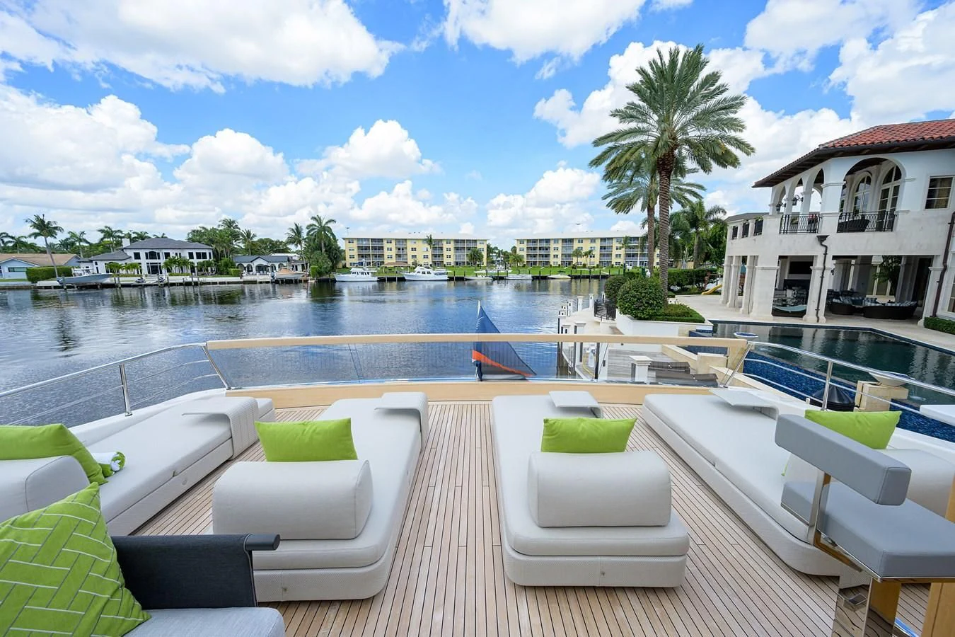 a pool with lounge chairs and a building in the background aboard PEARL Yacht for Sale