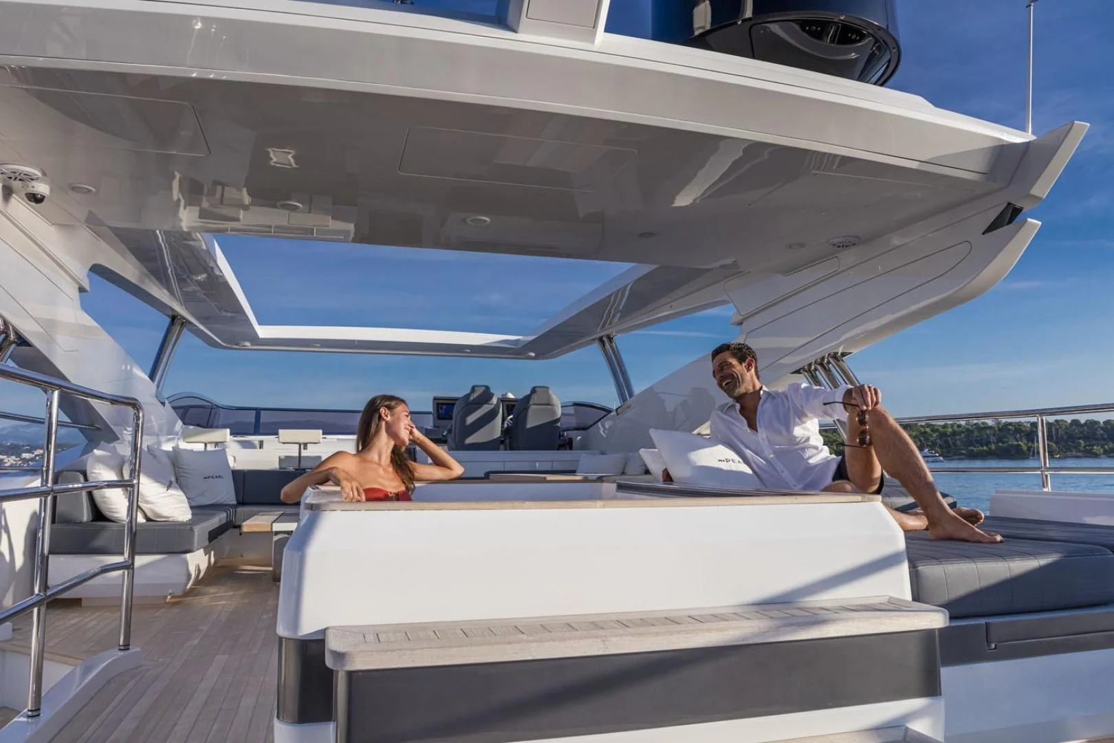 a couple sitting on a yacht aboard PEARL Yacht for Sale