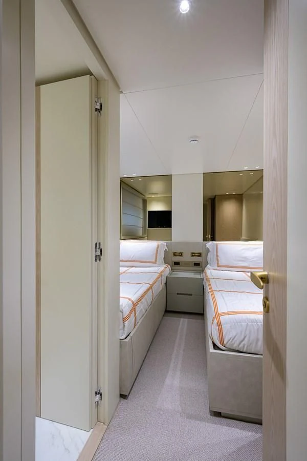a room with a bed and a mirror aboard PEARL Yacht for Sale