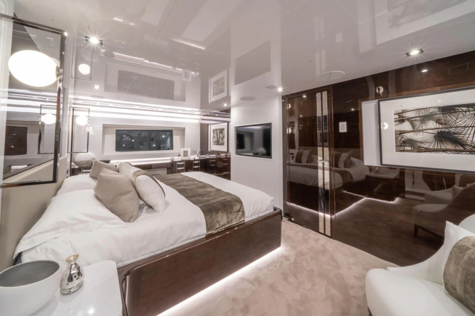 a bedroom with a bed and a mirror aboard PEARL Yacht for Sale