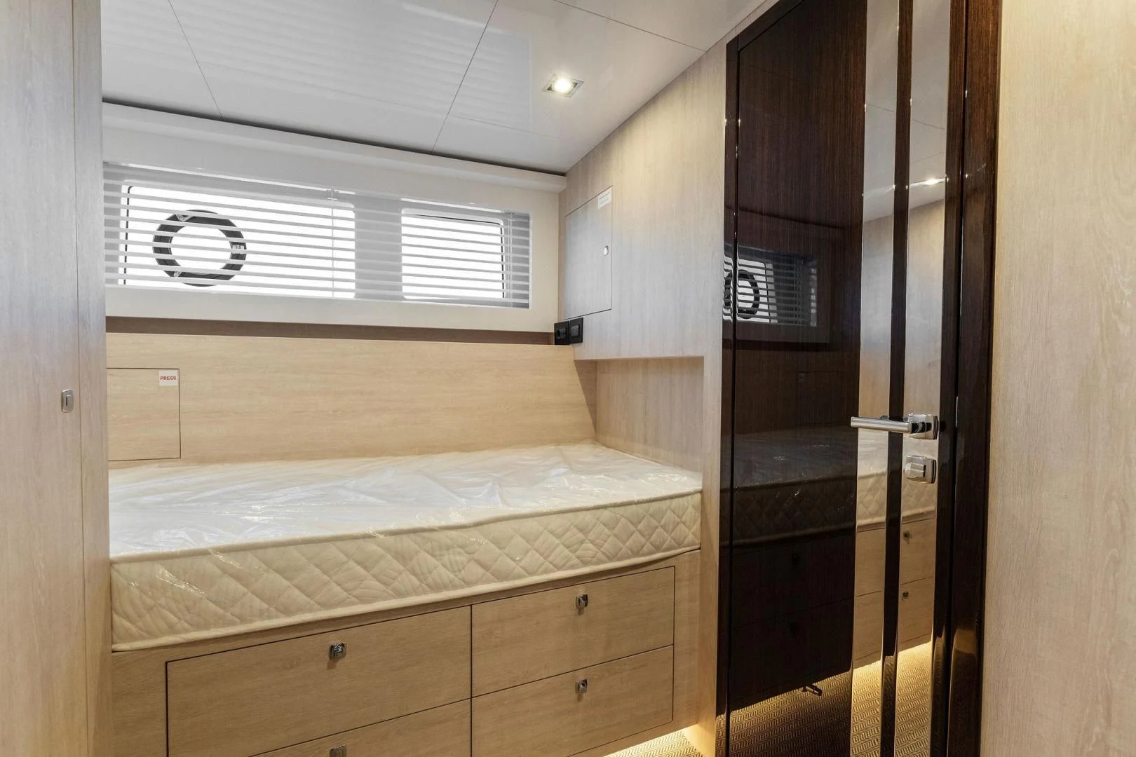 a room with a bed and a closet aboard PEARL Yacht for Sale