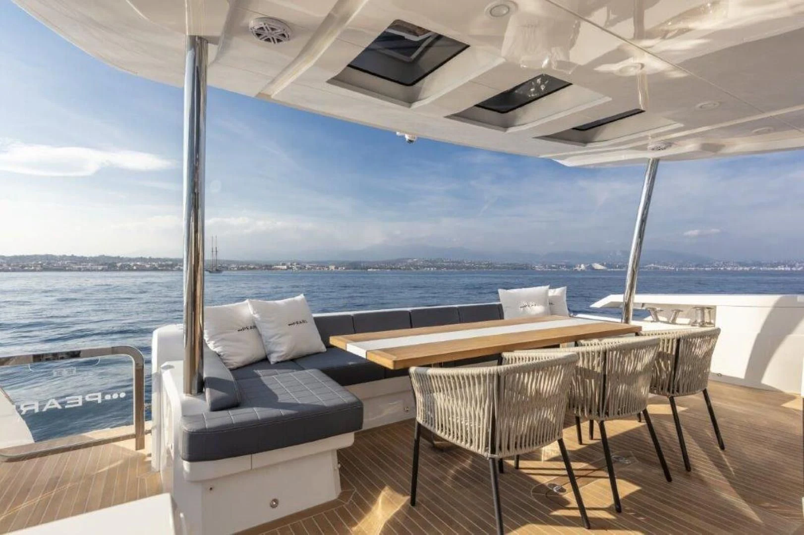 a table and chairs on a deck aboard PEARL Yacht for Sale