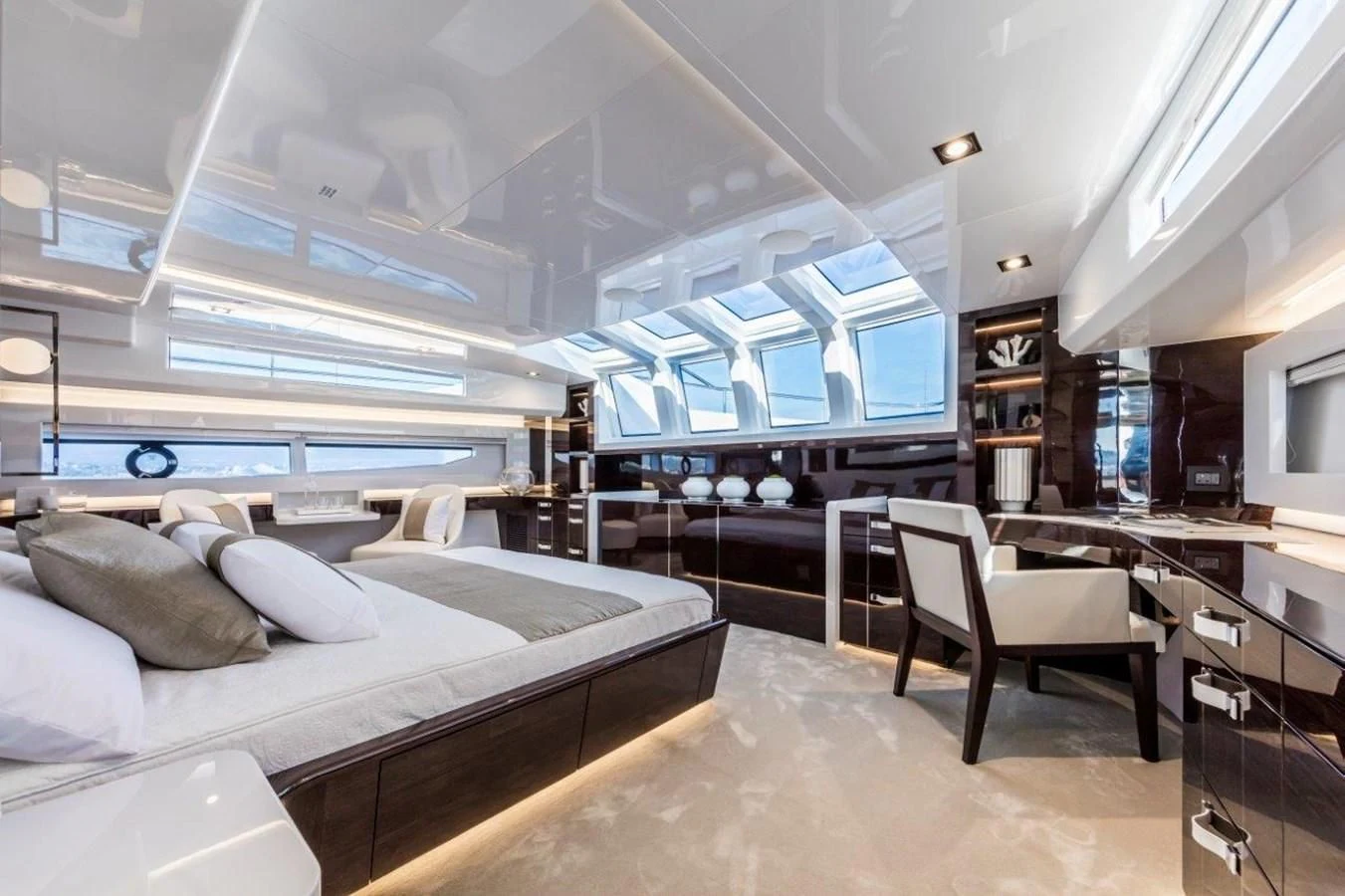 a room with a bed and a desk aboard PEARL Yacht for Sale
