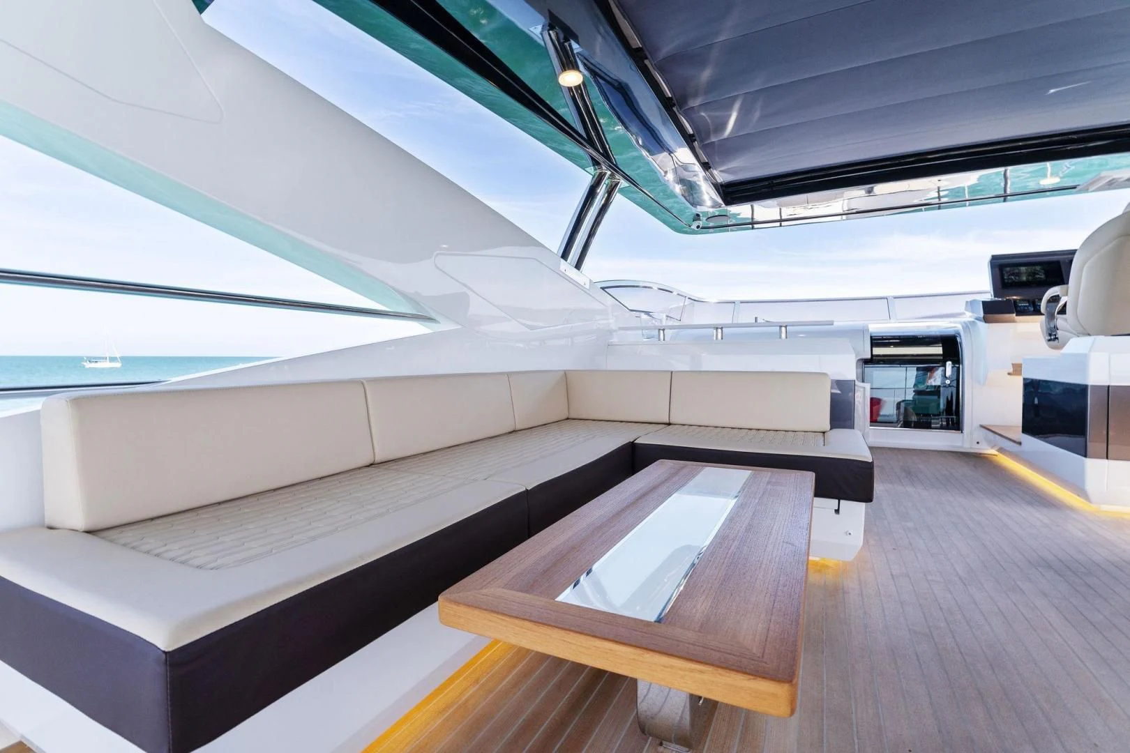 a room with a wood table and a large white wall aboard PEARL Yacht for Sale